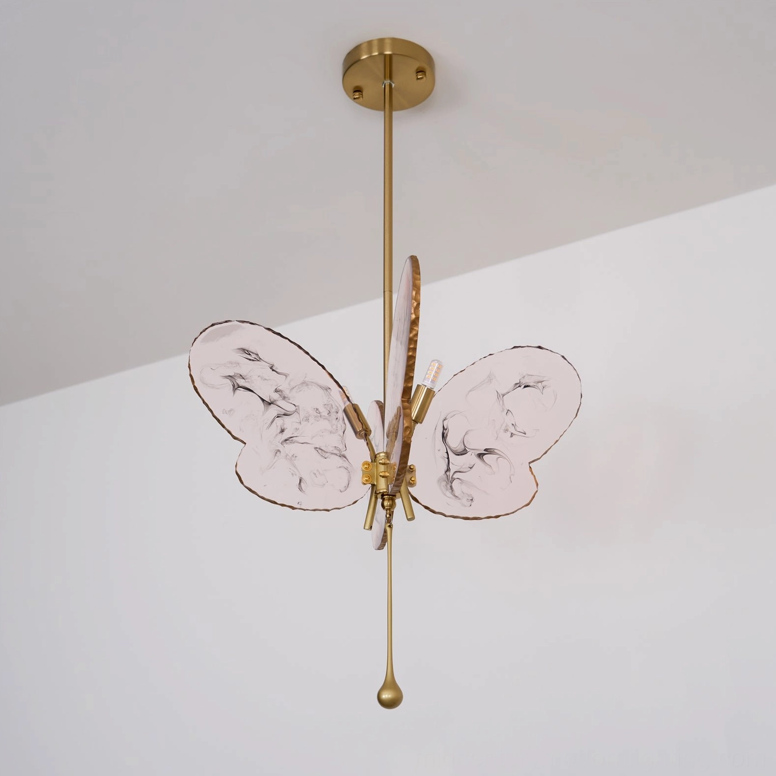 Pink marbled butterfly pendant lamp front view showcasing translucent resin wings and metalwork detail