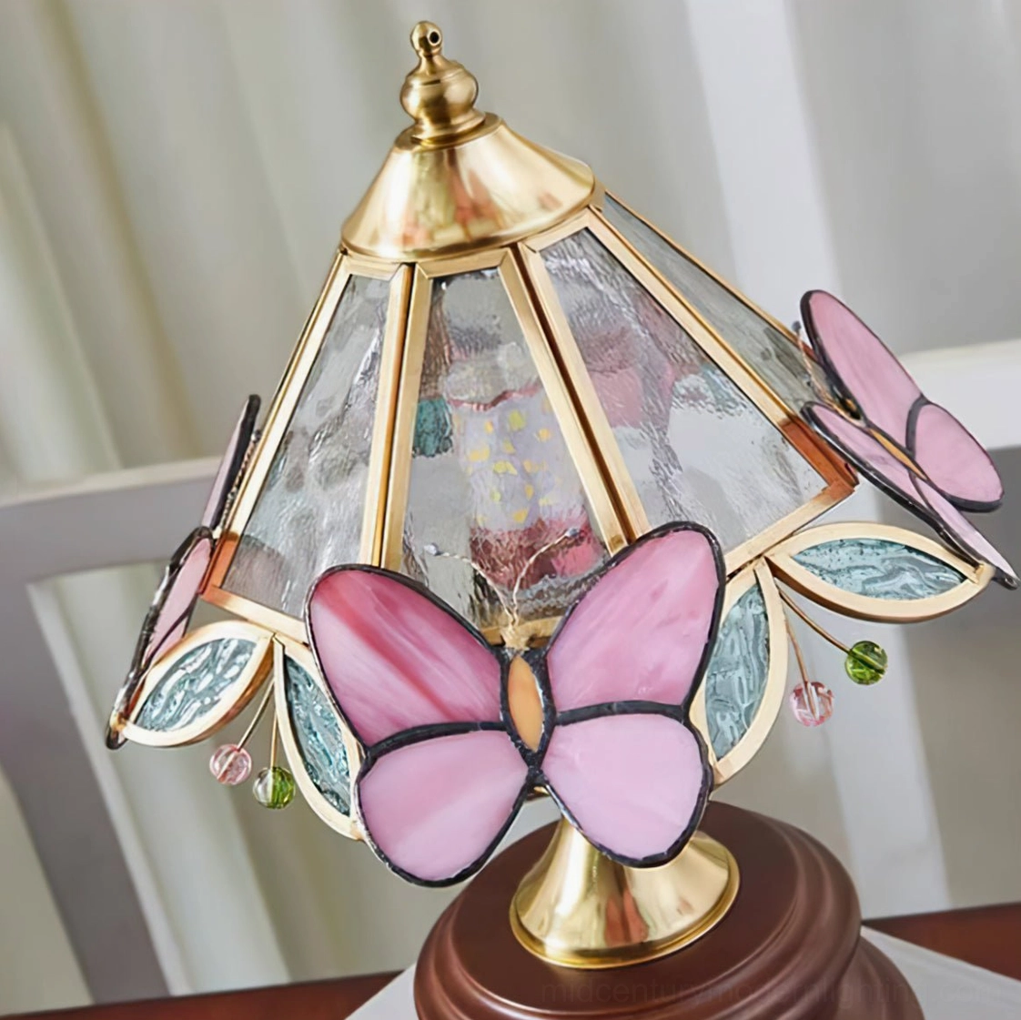 Close-up top view of Jenny Butterfly lamp shade showing stained glass panels, pink butterfly accents and crystal pendants