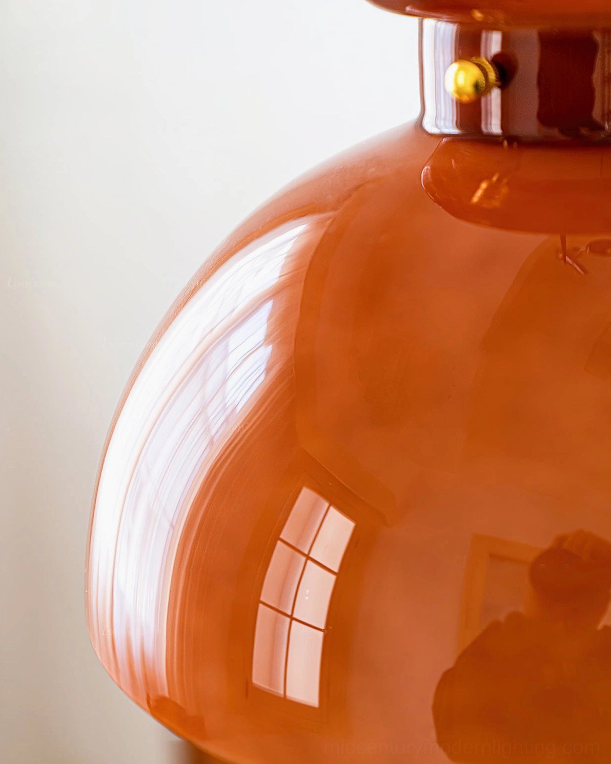 Close-up detail of Cabras pendant glass shade showing high-gloss caramel surface with window reflection and light refraction
