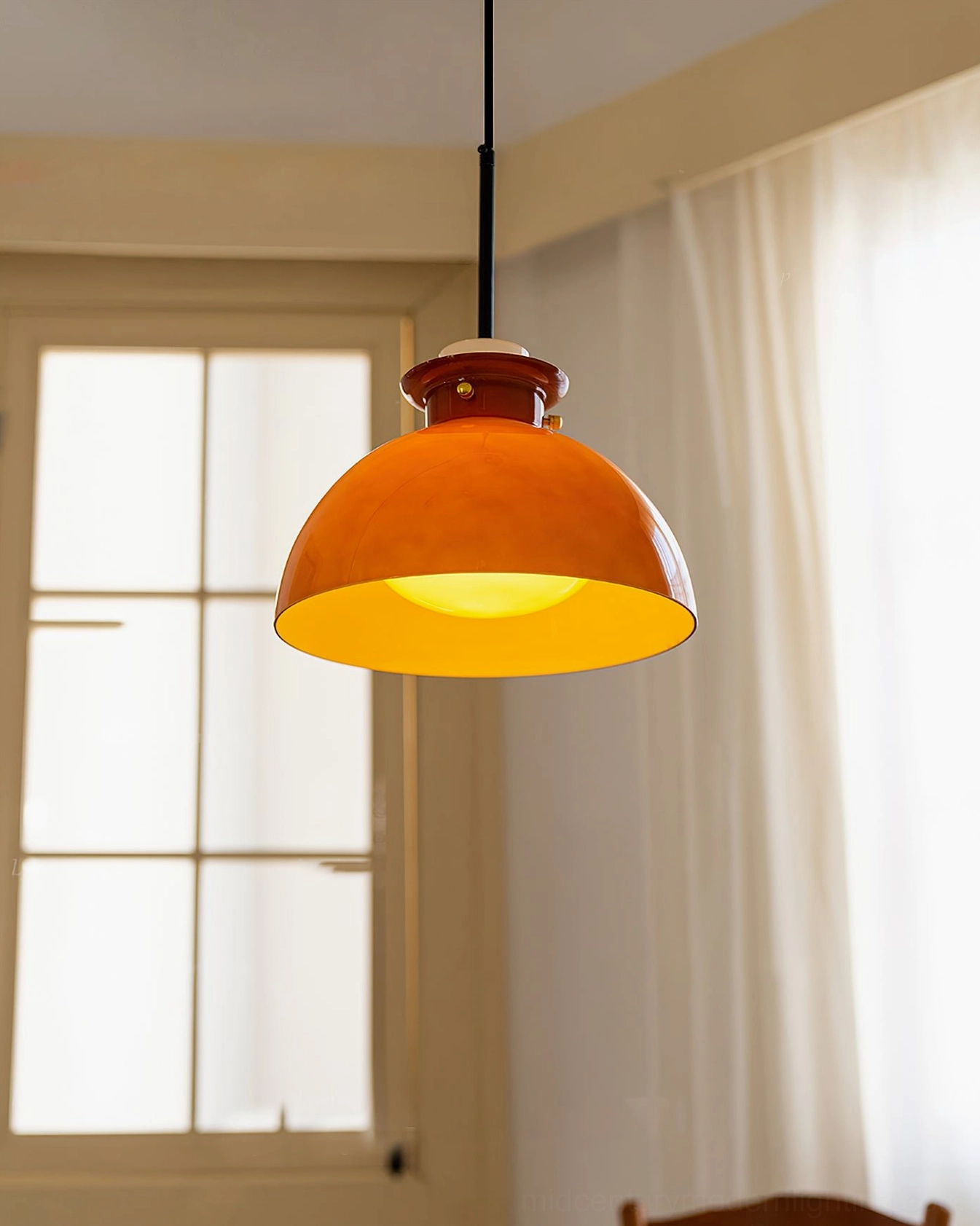 Cabras pendant ceiling light installed in cozy room with french window, low side angle view showing warm amber glowing light