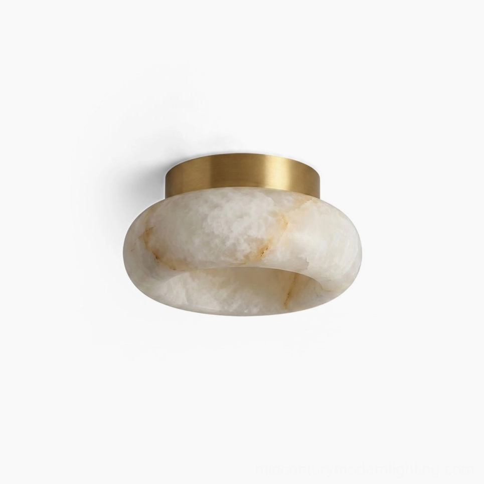 Cairns alabaster flush mount ceiling lamp with solid brass hardware and natural veined stone shade on white studio background