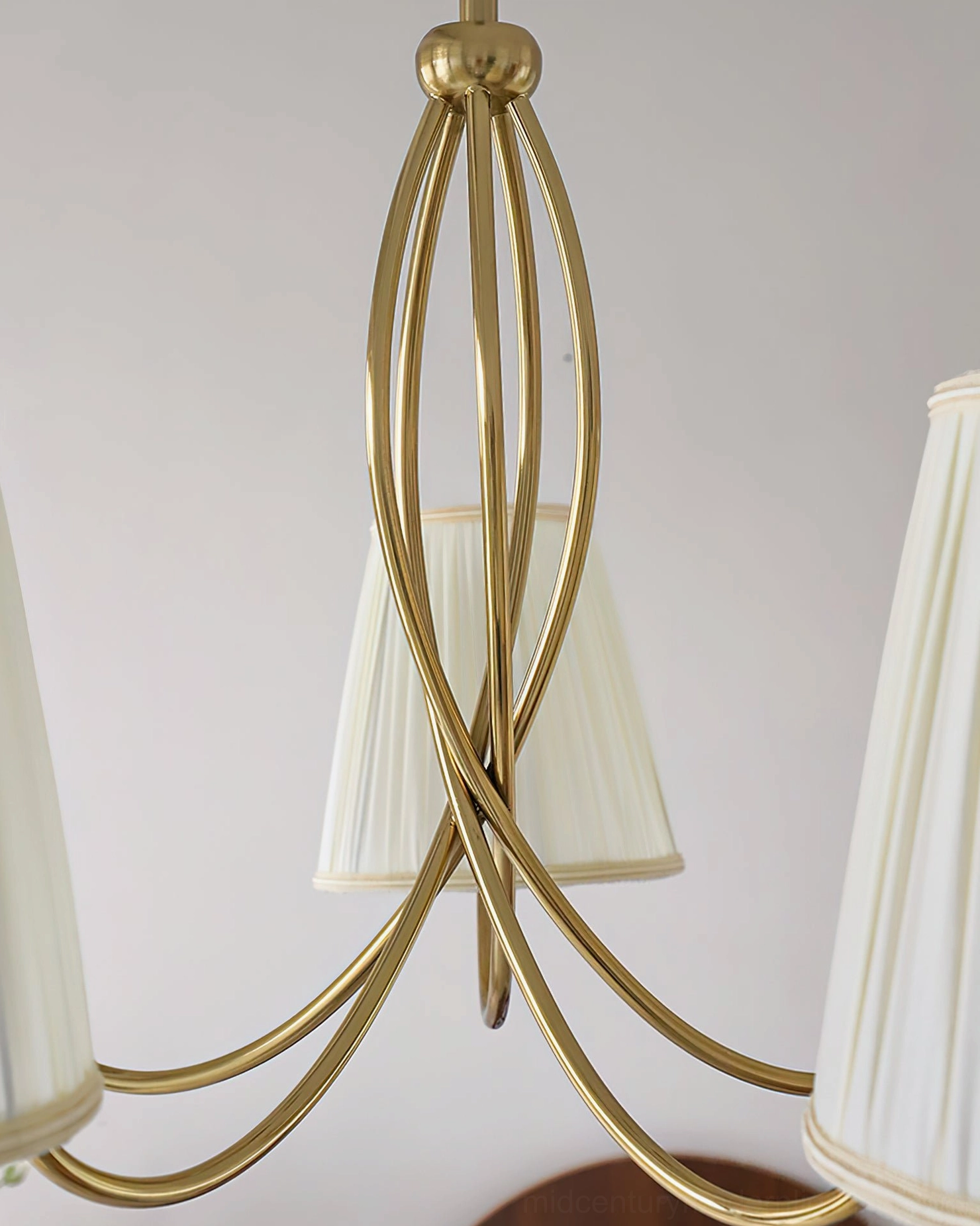 Calistoga brass chandelier in elegant dining room setting, creating ambient light over table