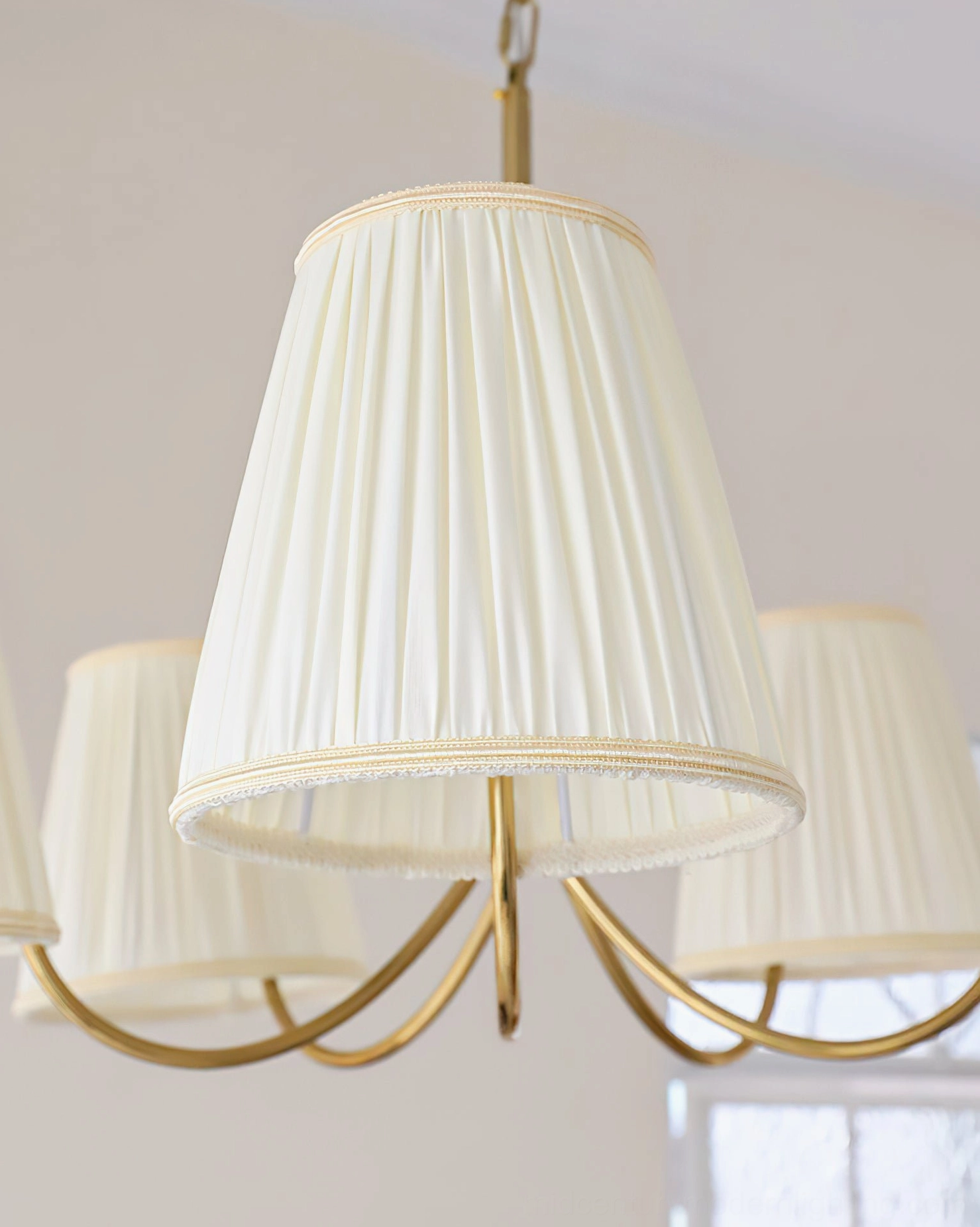 Calistoga 5-light chandelier close-up showing pleated fabric shade texture and brass arm construction
