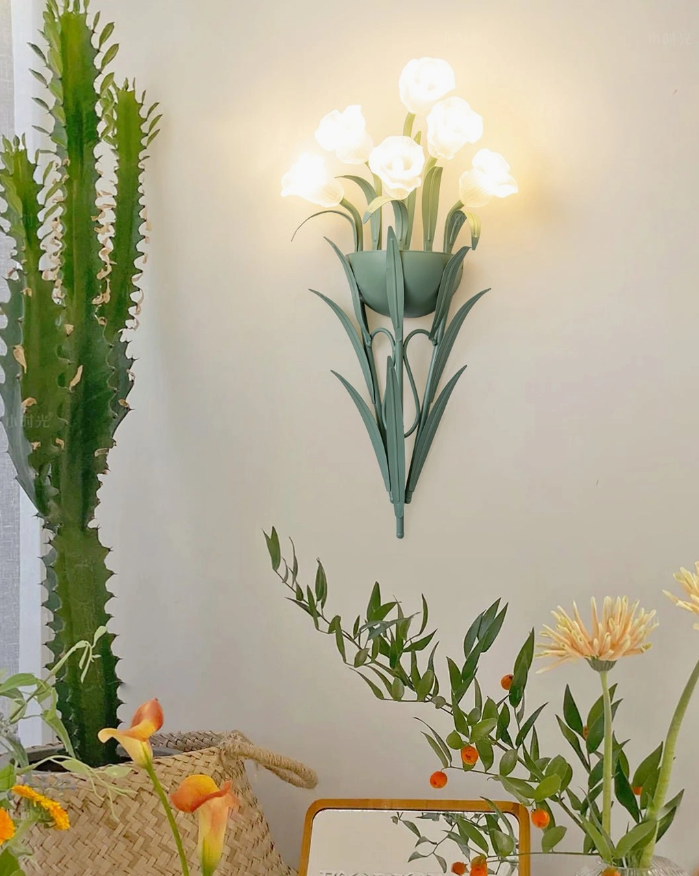 Illuminated floral wall lamp in bohemian home decor setting with plants