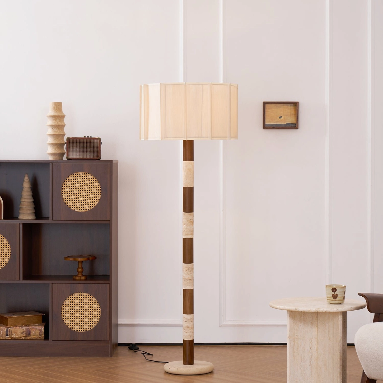 Calypso floor lamp three-quarter view in boho interior with rattan cabinet, walnut and travertine striped design