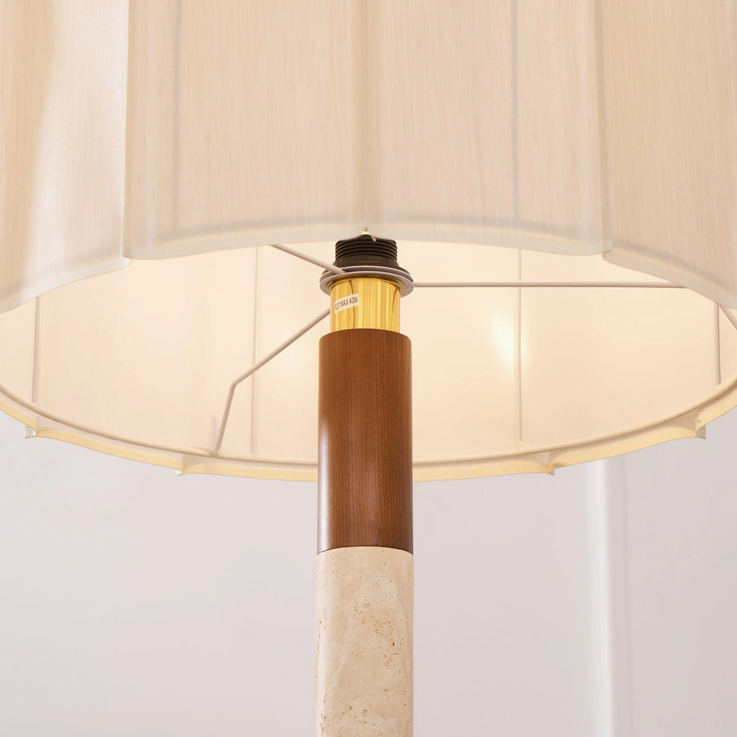 Calypso striped floor lamp showcasing layered walnut wood and travertine design in modern interior space