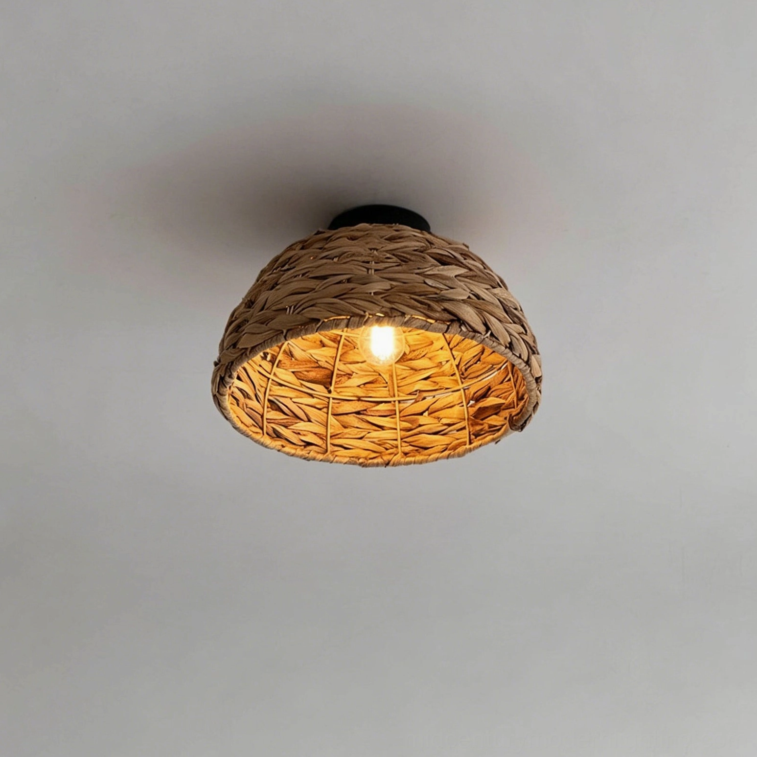 Cambria water hyacinth ceiling fixture side view warm lit showing woven leaf pattern shade construction detail