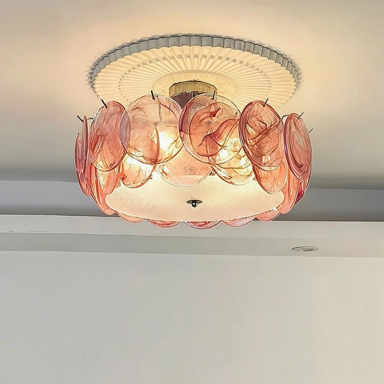 Layered pink marbled glass ceiling lamp with warm interior lighting, overhead frontal view