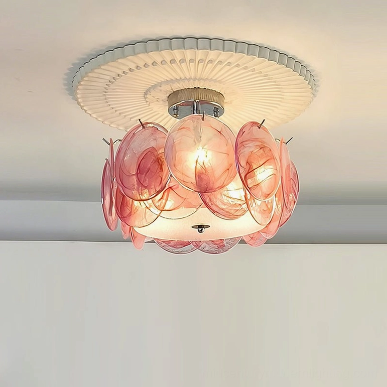 Pink illuminated glass petal ceiling light, overhead frontal view showing warm glow and chrome top fixture