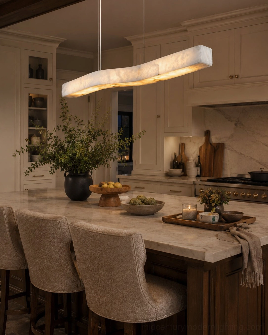Camur linear alabaster chandelier above rustic farmhouse kitchen dining bar with warm earthy neutral tones