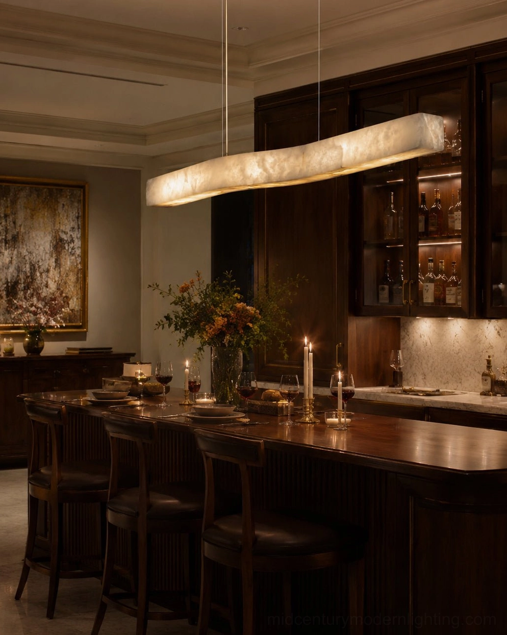 Camur brass and alabaster chandelier creating warm ambient light in moody dark wood home dining bar area