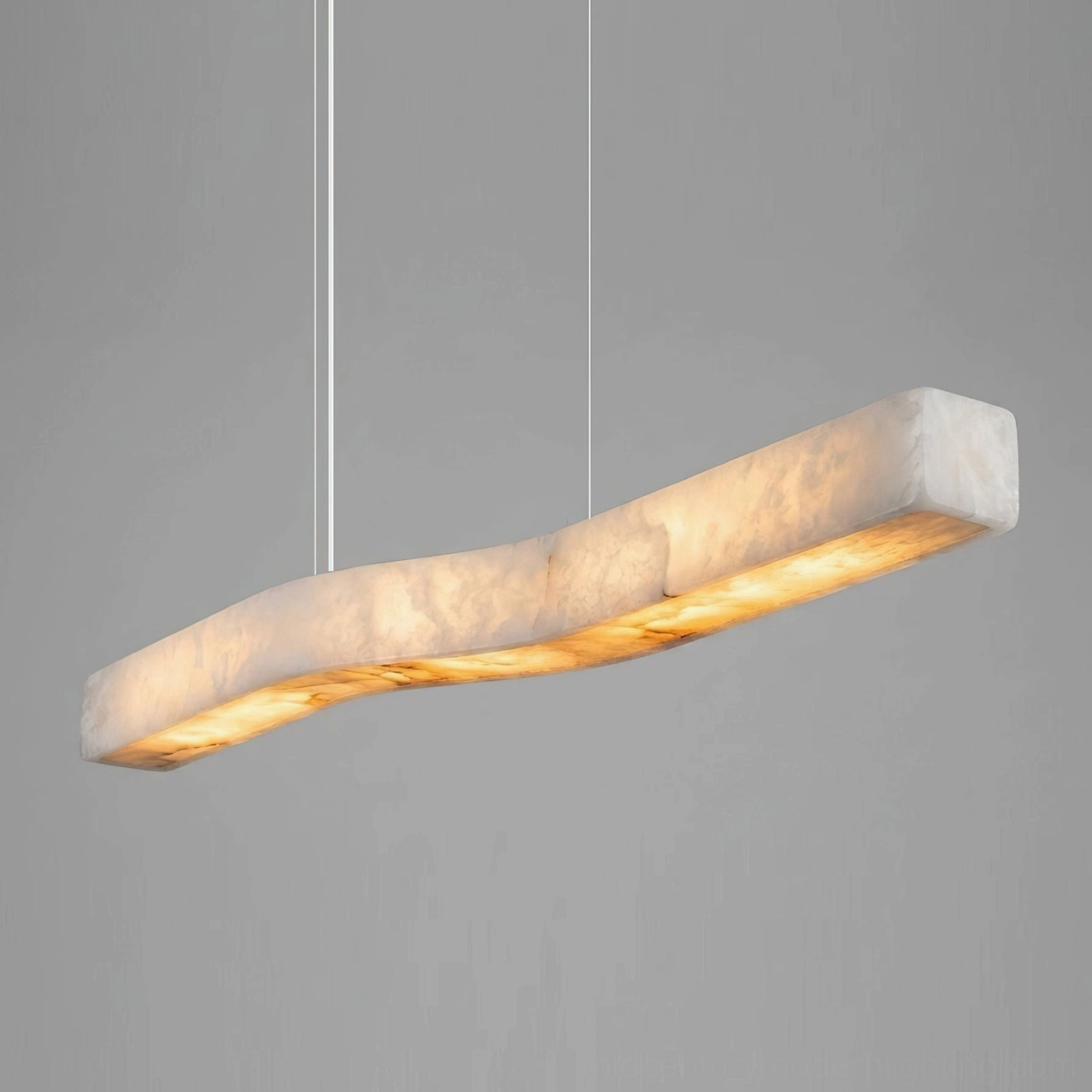 Camur handcrafted alabaster and brass suspension pendant showing integrated LED warm light and translucent stone characteristics
