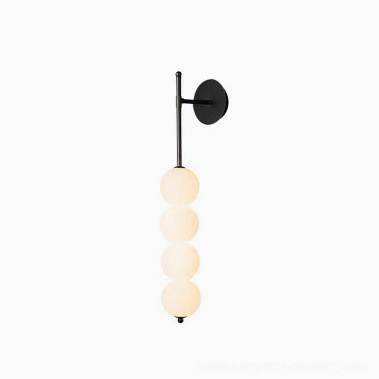 Candied Haws brass wall sconce available in black and gold finish with frosted glass options