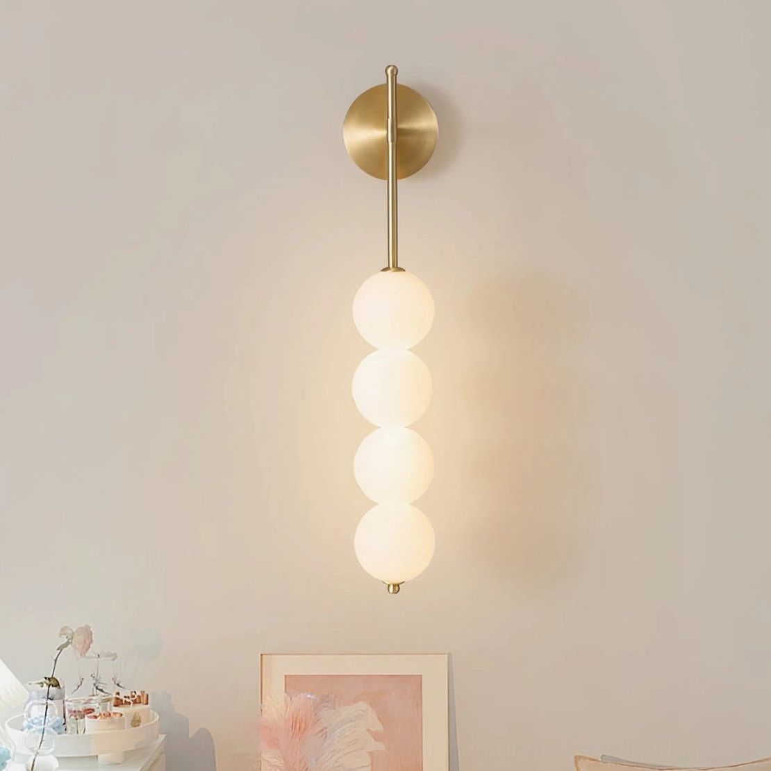 Candied Haws sconce detail showing sculptural brass frame with frosted glass globe elements