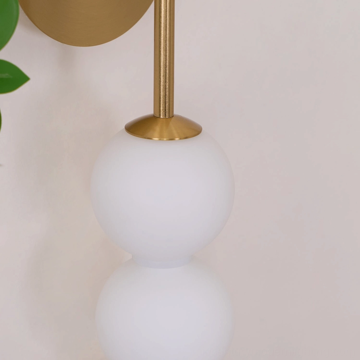 Candied Haws wall sconce detail view showing unlit frosted white glass beads and brass metal mounting rod