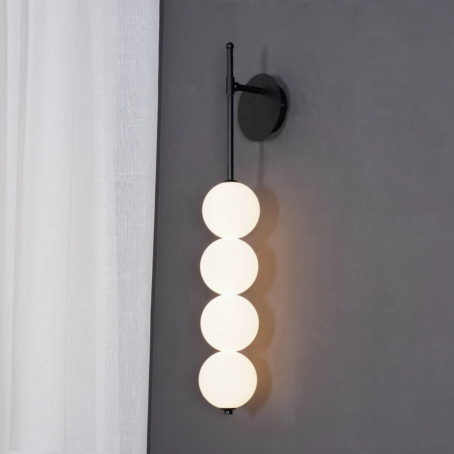 Candied Haws brass sconce showing glass diffusion and soft light distribution through frosted spheres