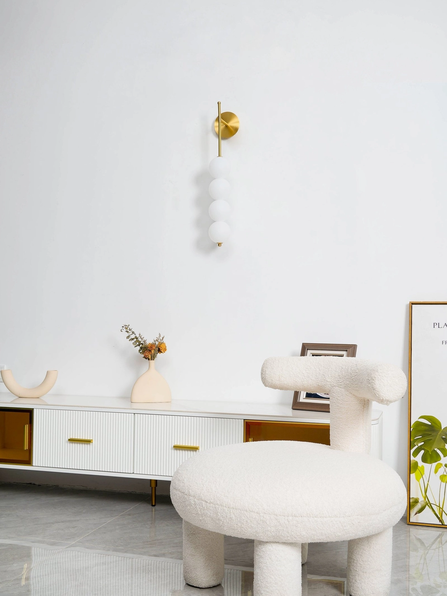 Candied Haws brass sconce paired with minimalist wall decor in modern home interior design
