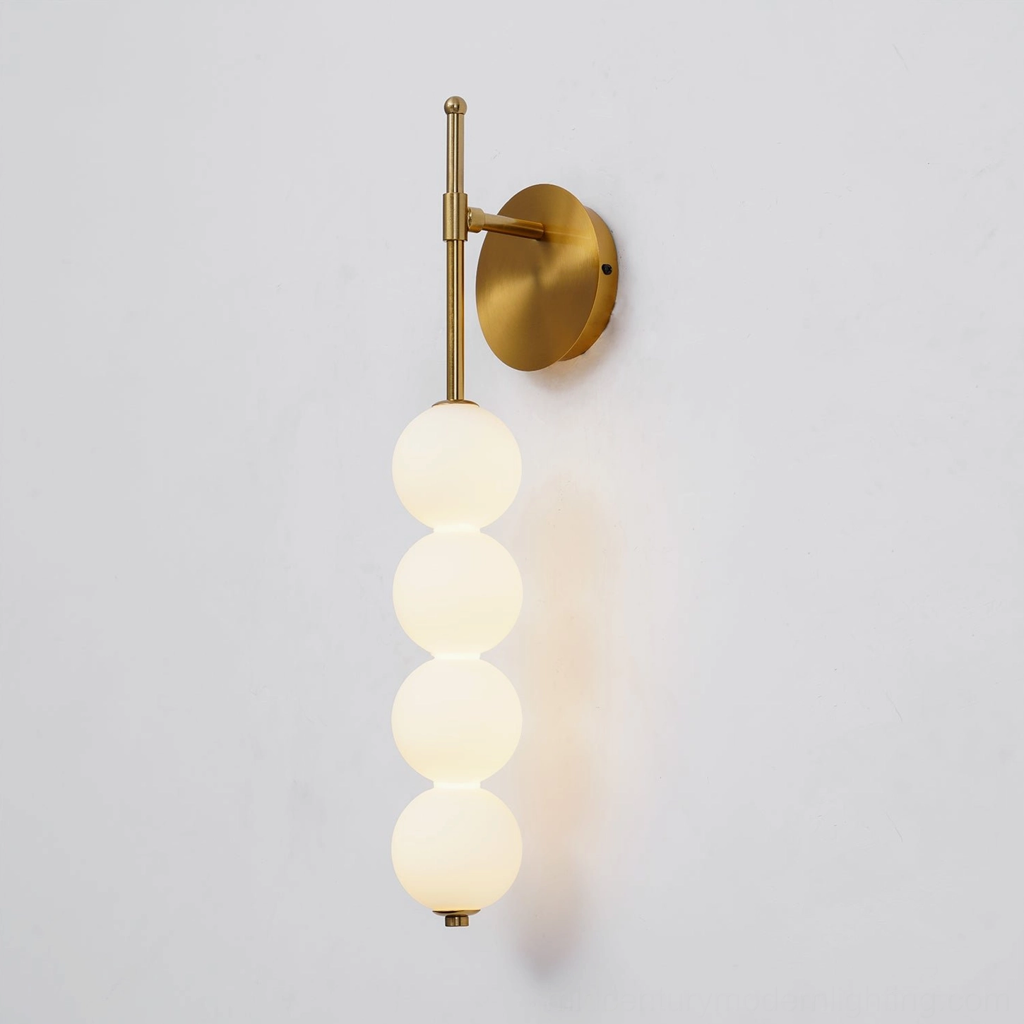 Candied Haws wall sconce showing spherical glass elements casting geometric shadow patterns