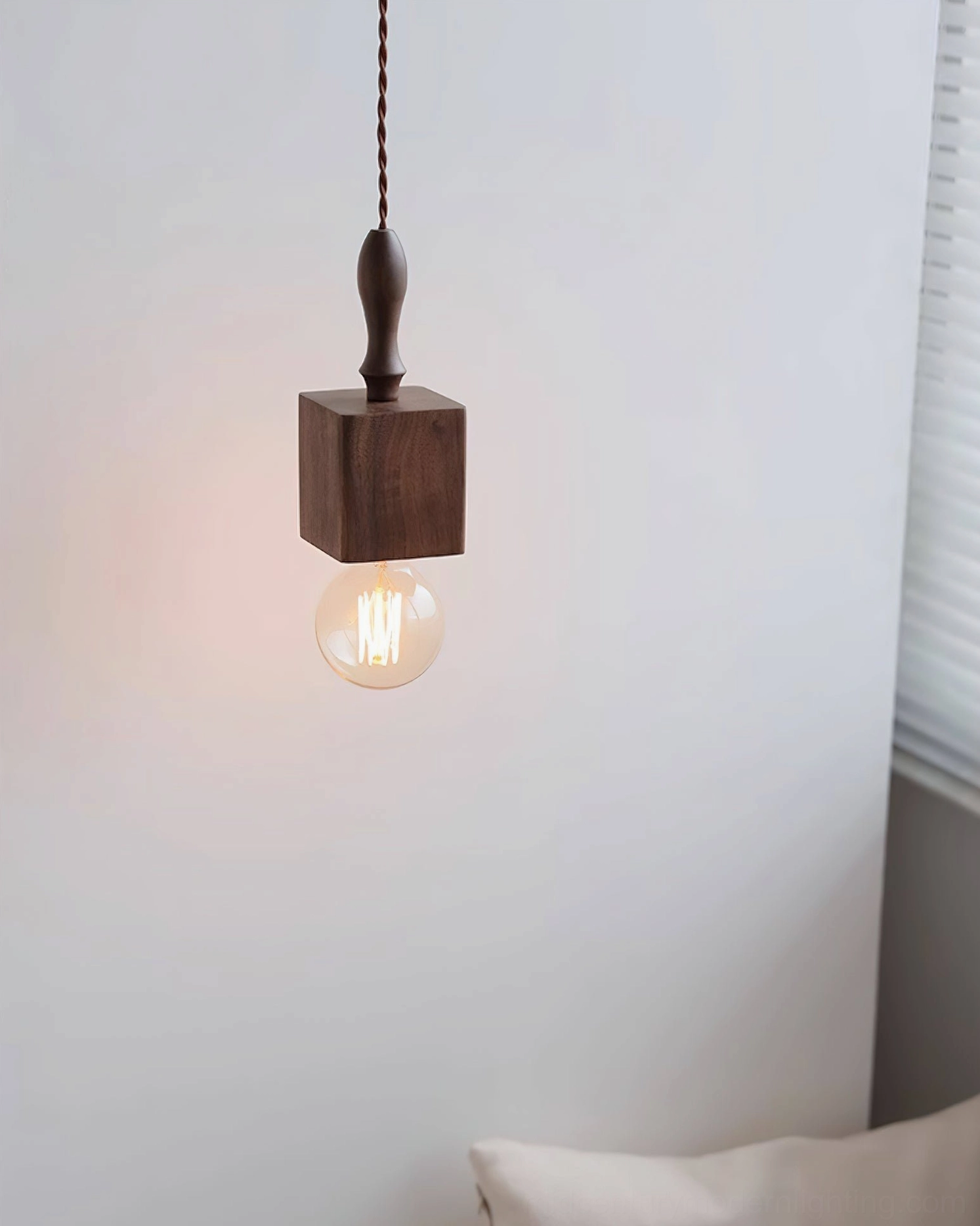 Cano dark square wooden pendant light with warm Edison bulb glow, modern interior setting