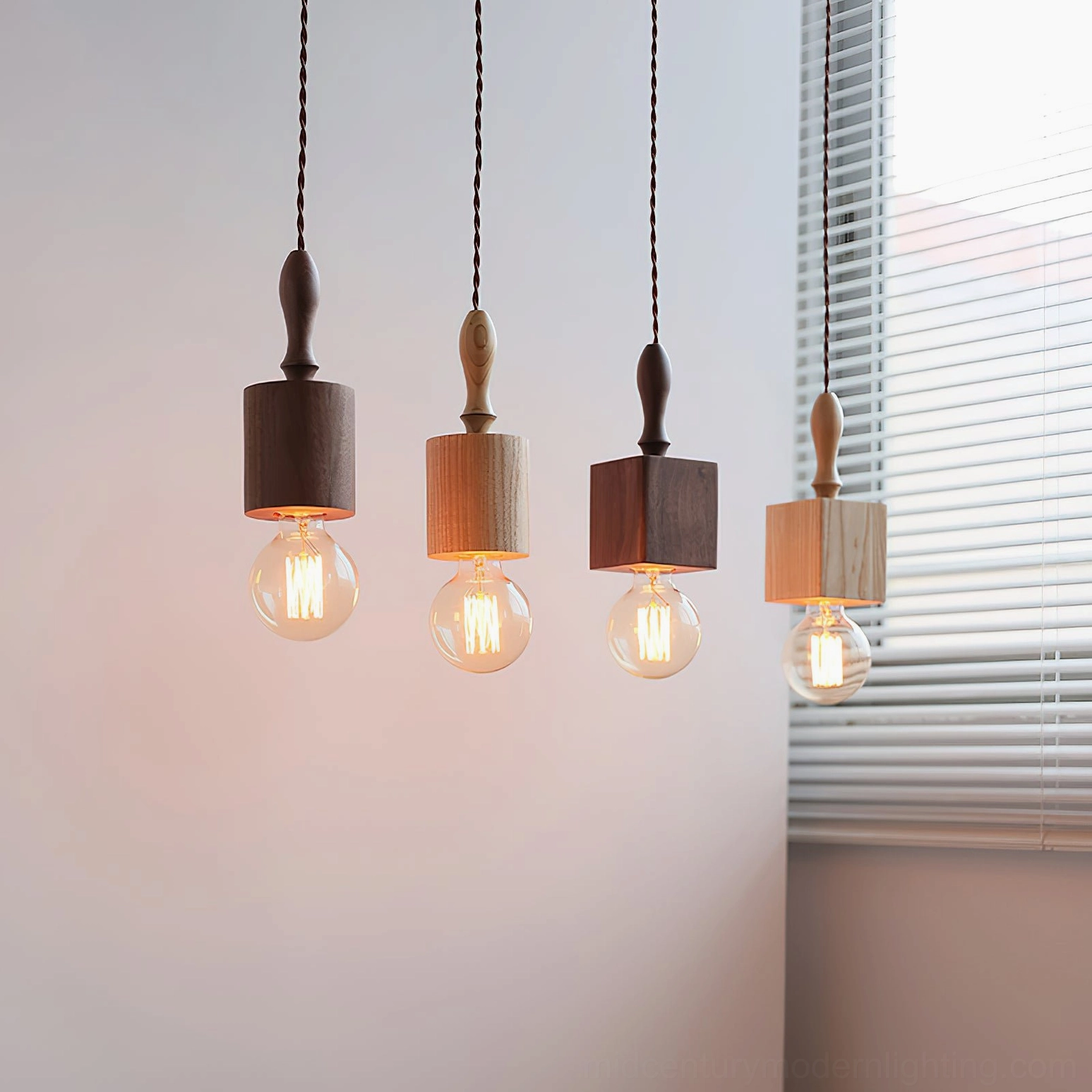 Cluster of four Cano wooden pendant lights in mixed finishes with warm filament bulbs, indoor hanging display