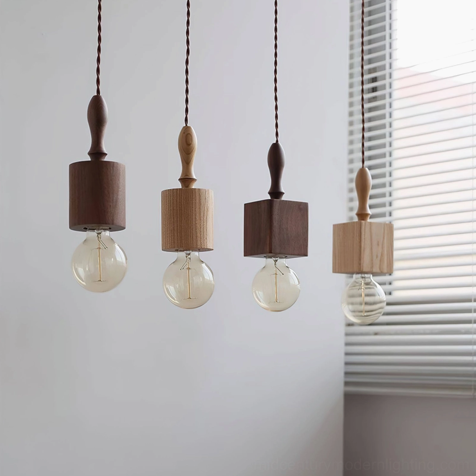 Four-piece Cano pendant light collection featuring mixed walnut and natural wood finishes