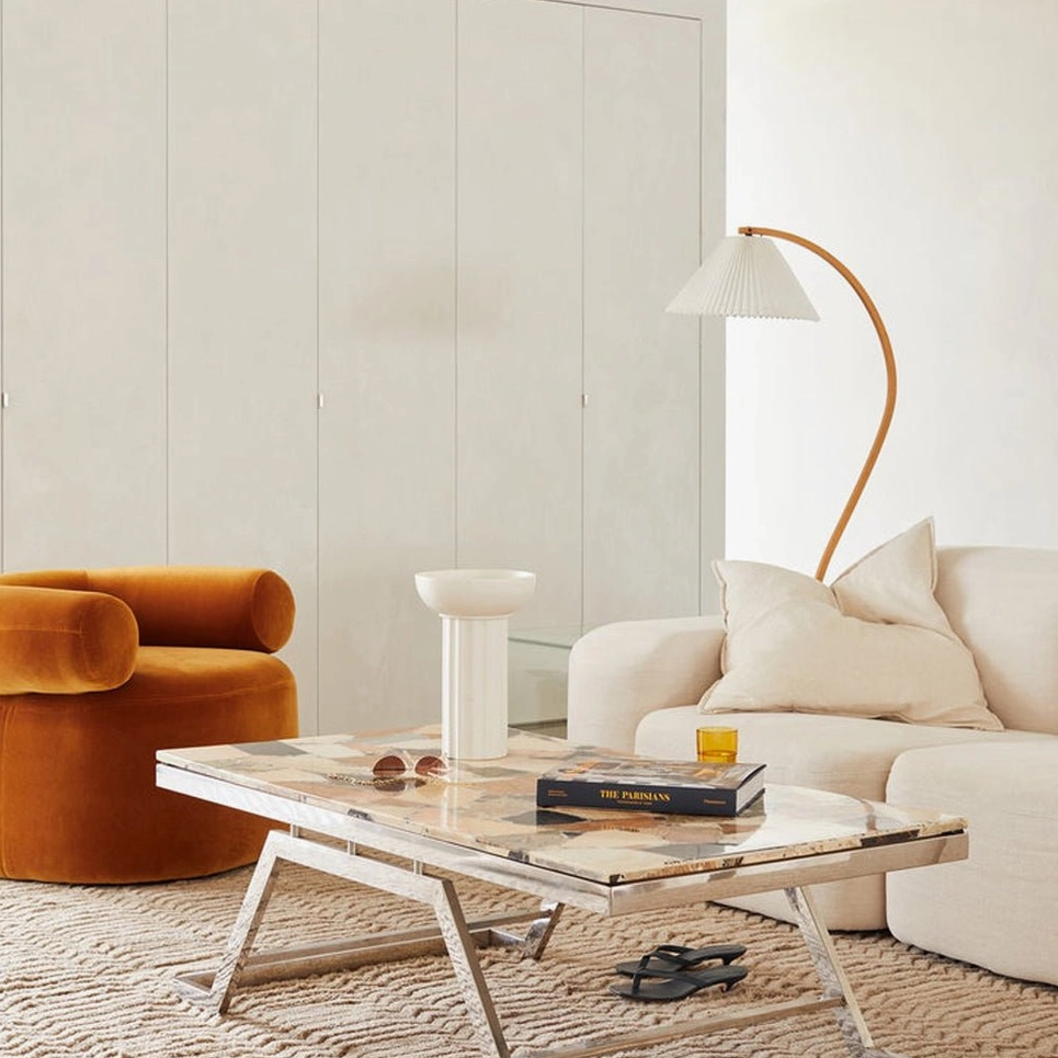 Caprani wood floor lamp in contemporary living room with velvet armchair and marble coffee table
