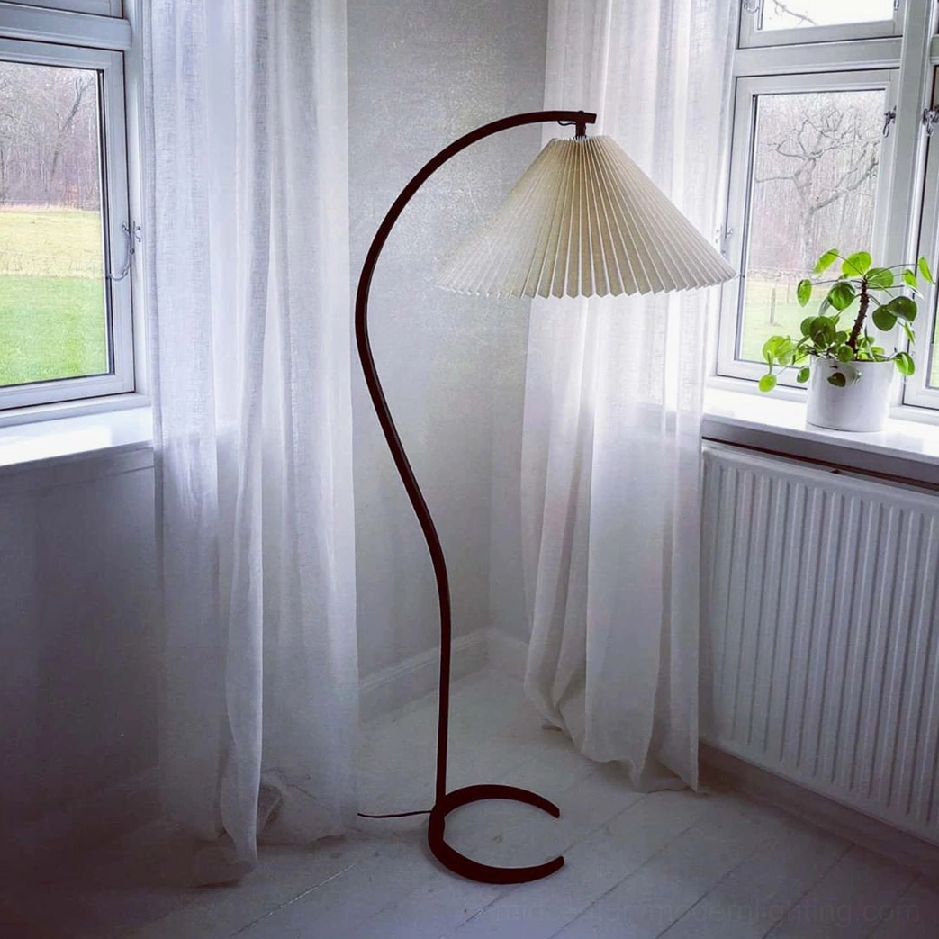 Caprani dark beech wood floor lamp with C-shaped cast-iron base, beige pleated linen shade detail