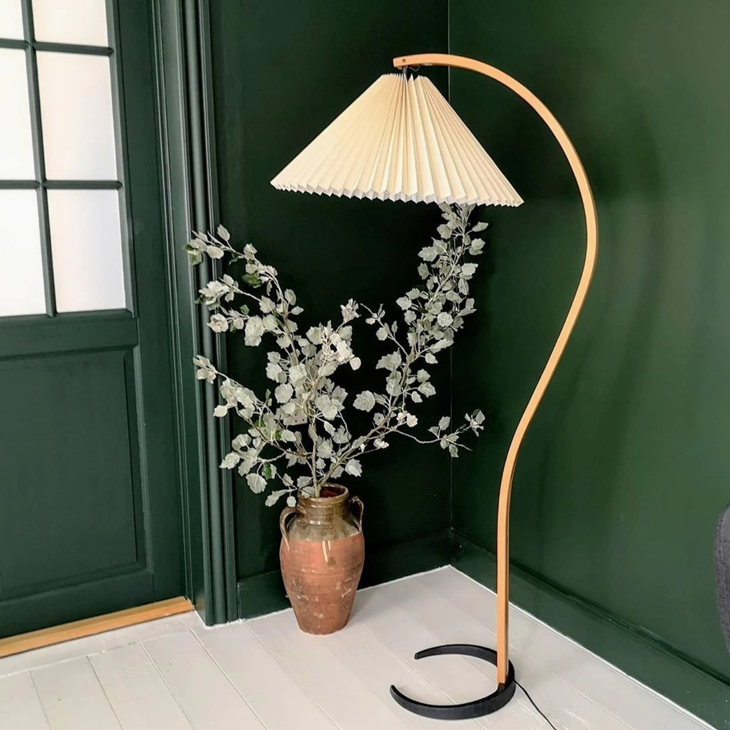 Caprani floor lamp with coffee-colored linen shade in cozy reading corner ambiance