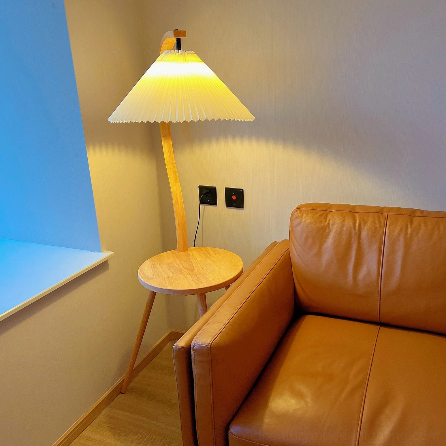 Caprani tray lamp positioned in corner space demonstrating space-efficient room lighting solution