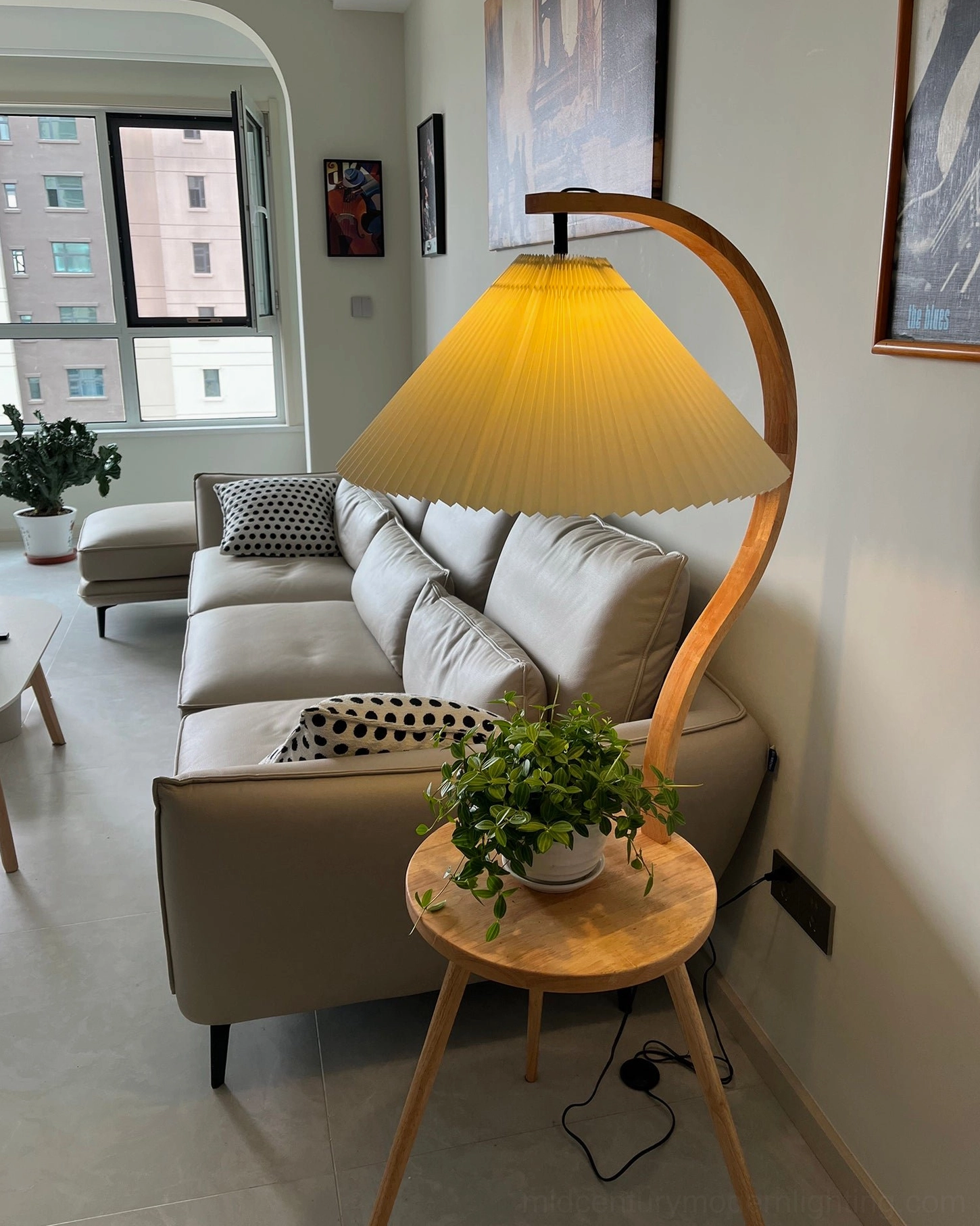 Caprani mid-century modern floor lamp featuring curved wood base and integrated storage side table