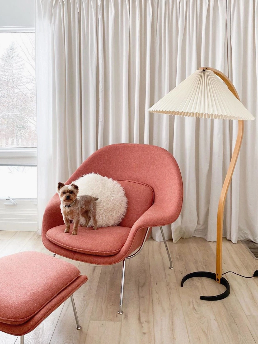 Caprani floor lamp beside pink accent chair in bright window-side living nook with sheer curtains