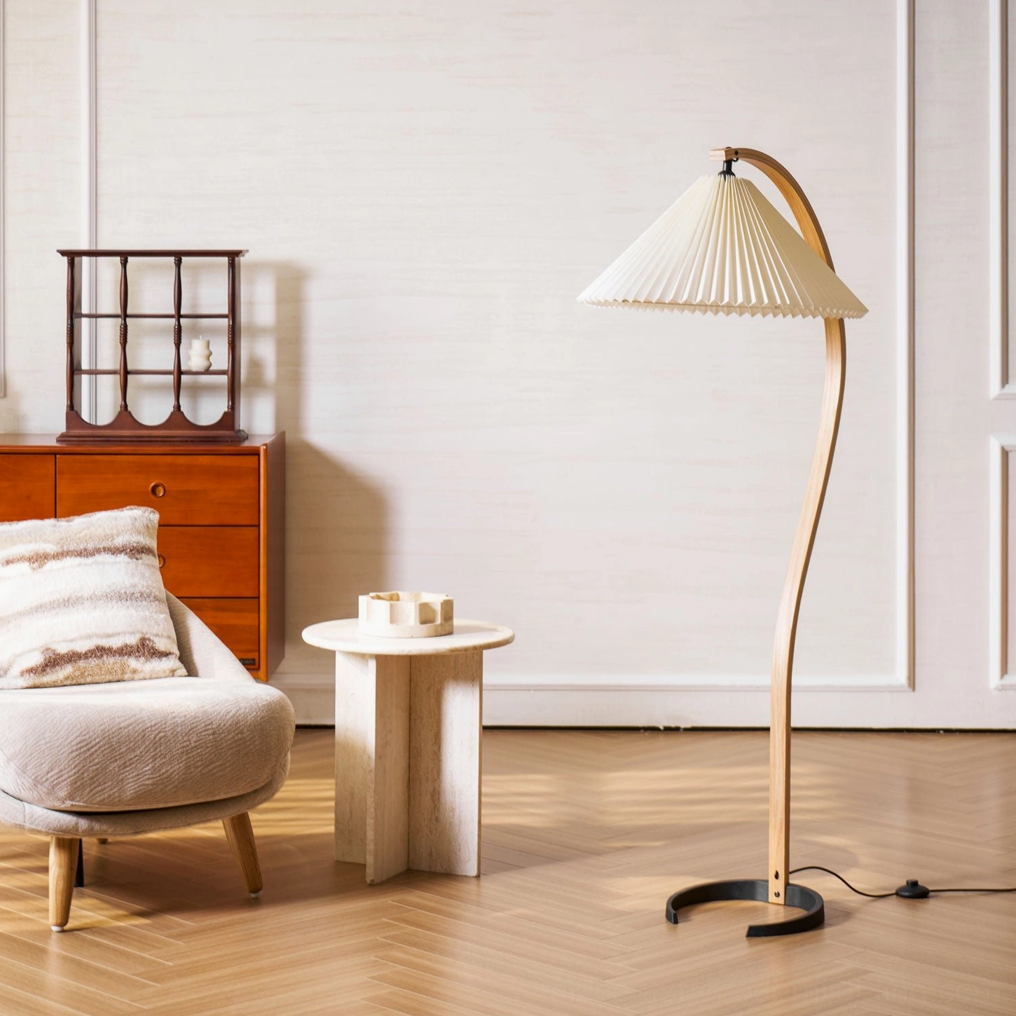 Caprani Scandinavian floor lamp three-quarter view in minimalist warm-toned living space with wooden dresser