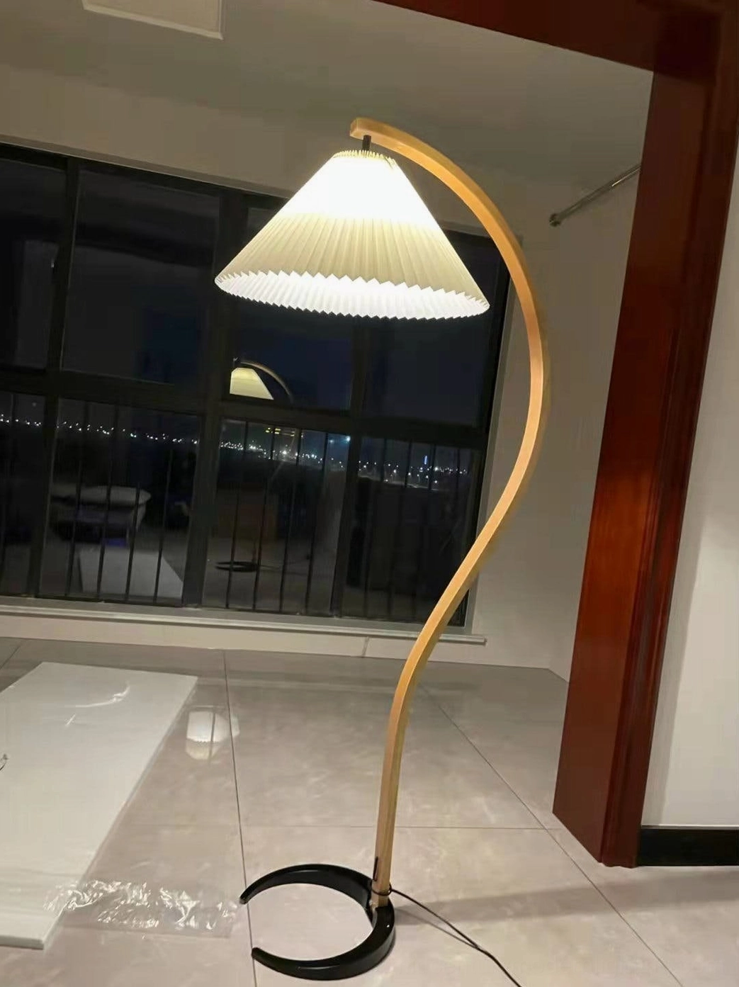 Caprani floor lamp with round linen pleated shade showing light diffusion and design