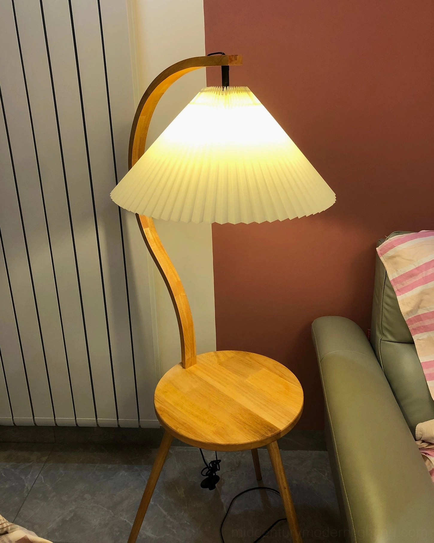 Caprani floor lamp positioned beside seating in Scandinavian-inspired interior design space
