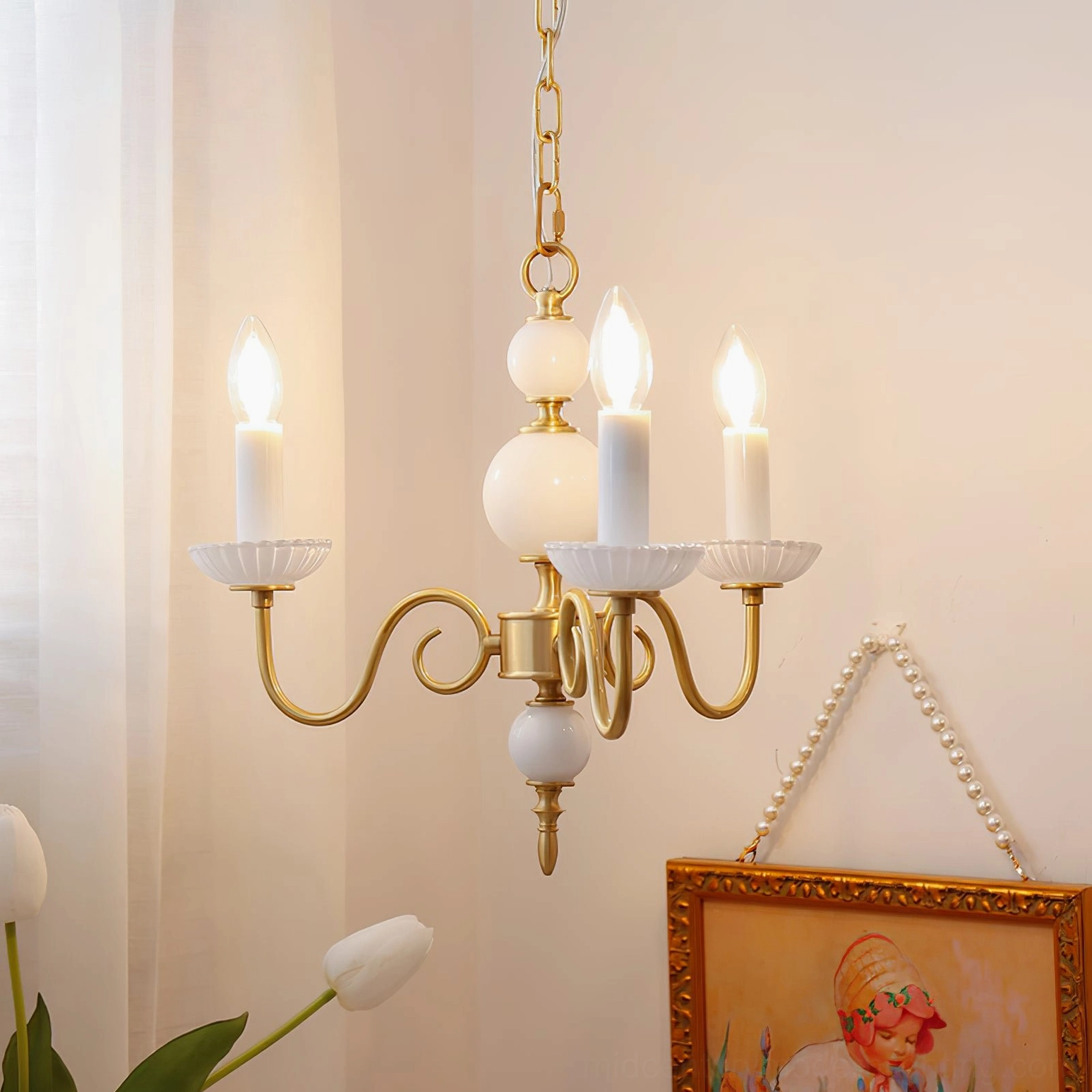 Carlita 3-light brass chandelier hanging in cozy home interior with curtain and framed artwork