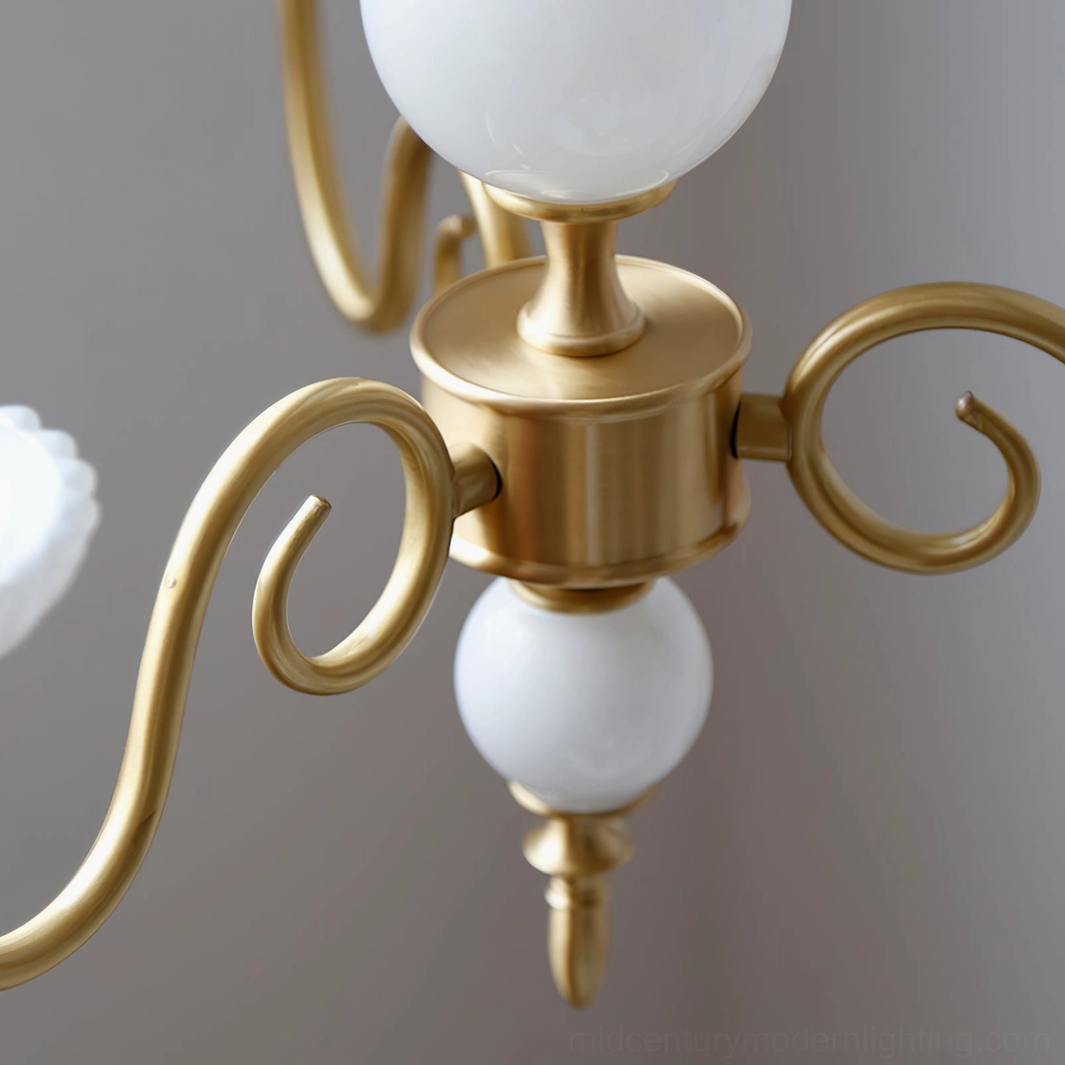 Carlita brass chandelier detail view of ceramic sphere accents and brass construction