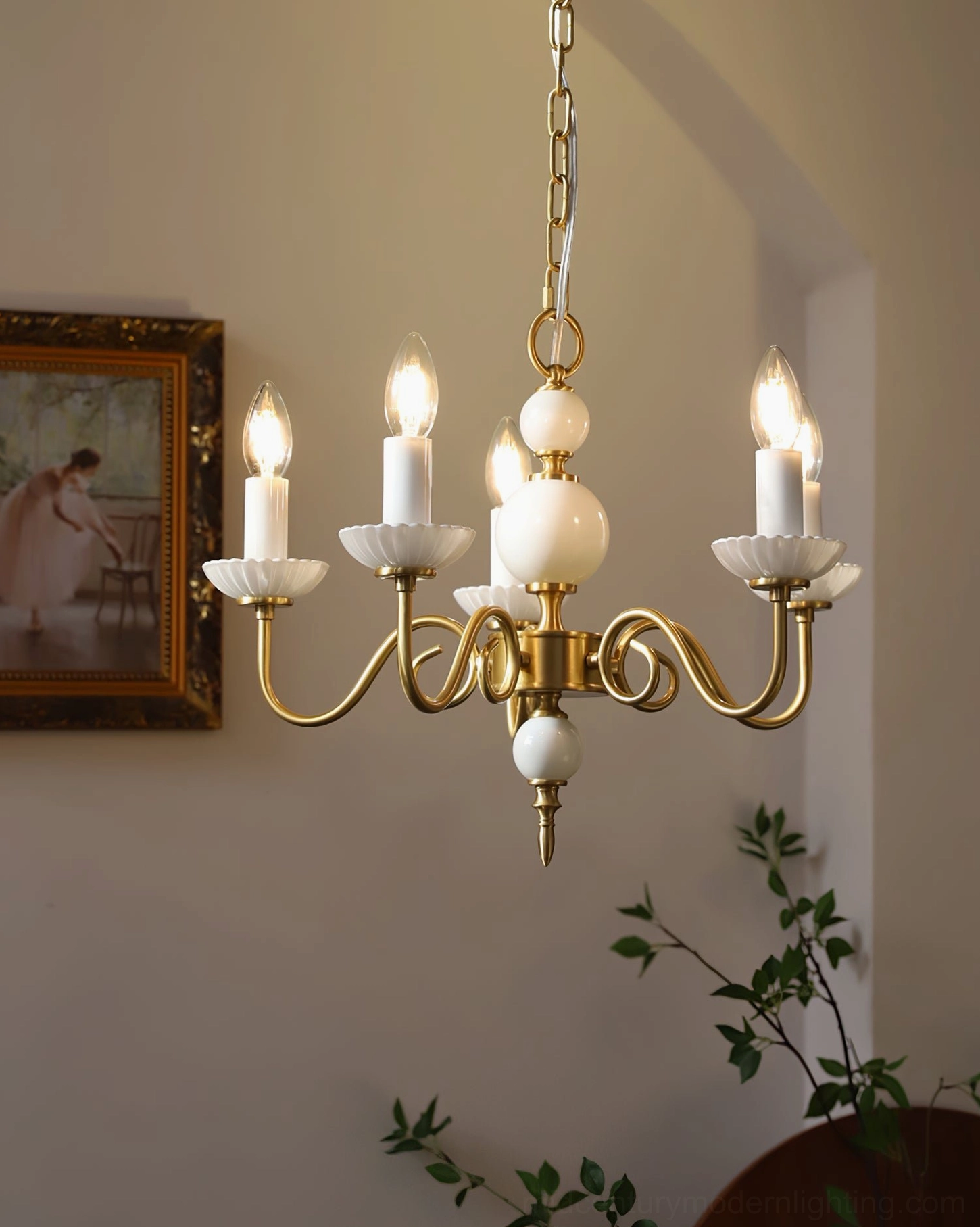 Carlita chandelier detail showing ceramic accents and brass arm joints