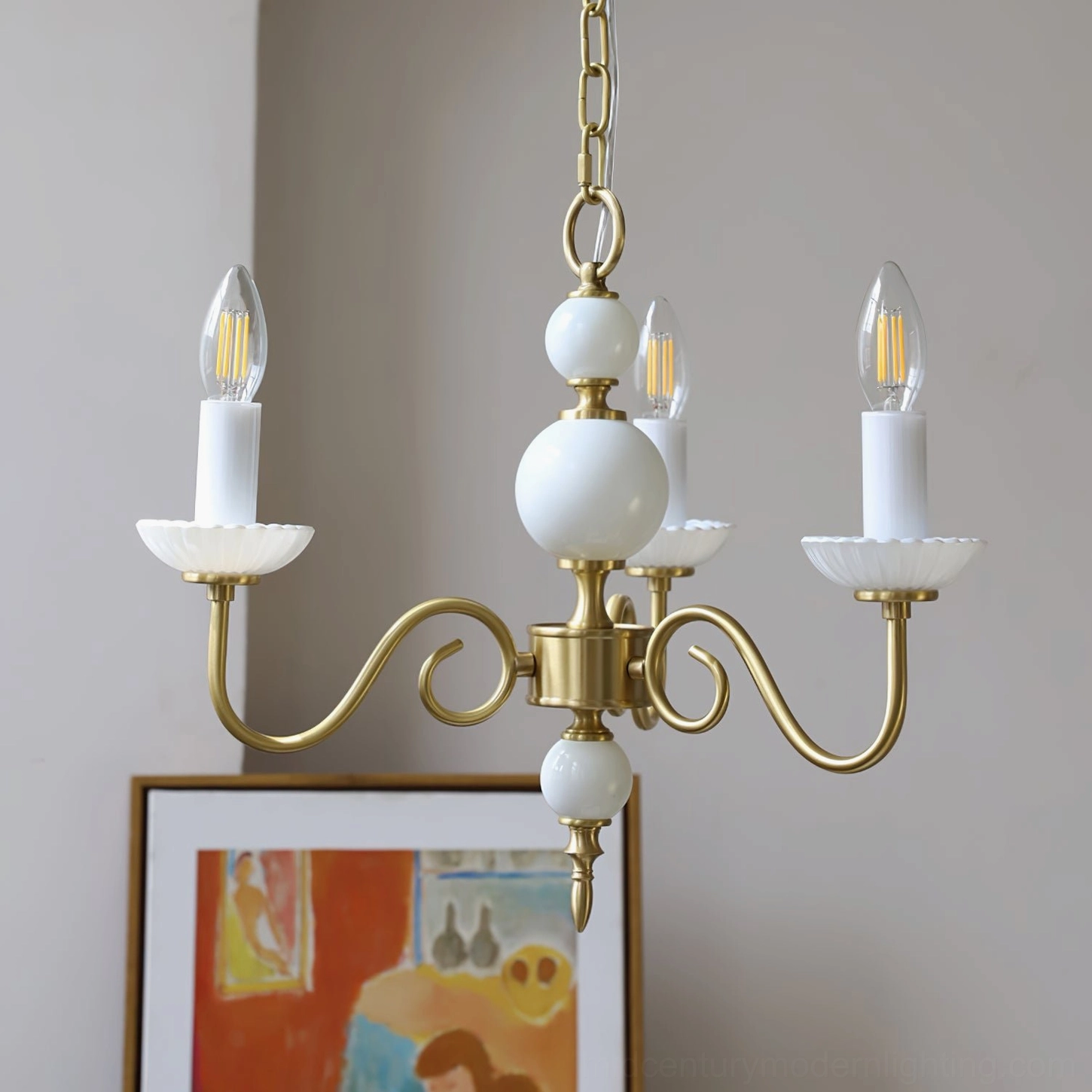 Carlita brass chandelier showing sculptural curved arms and refined proportions