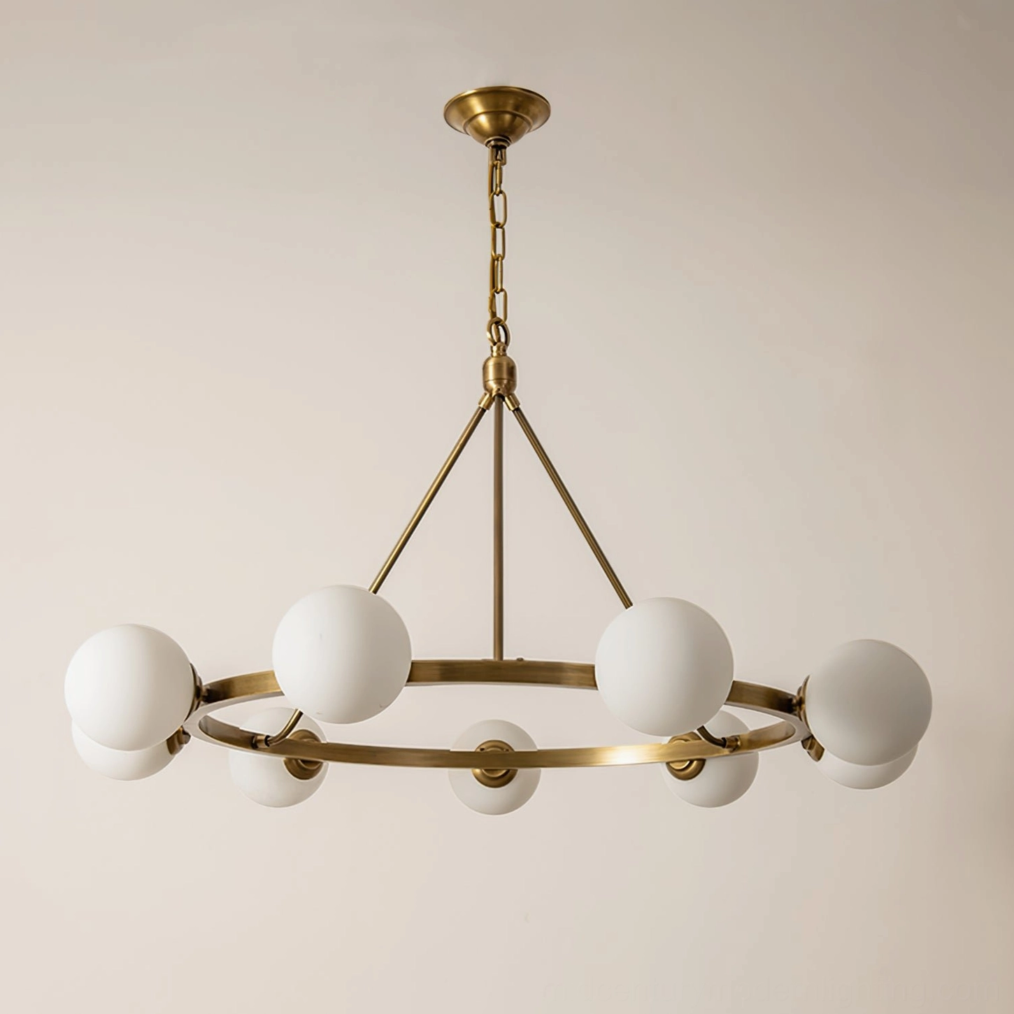 Carolee antique brass ring chandelier with frosted white glass globes, warm studio lighting detail view