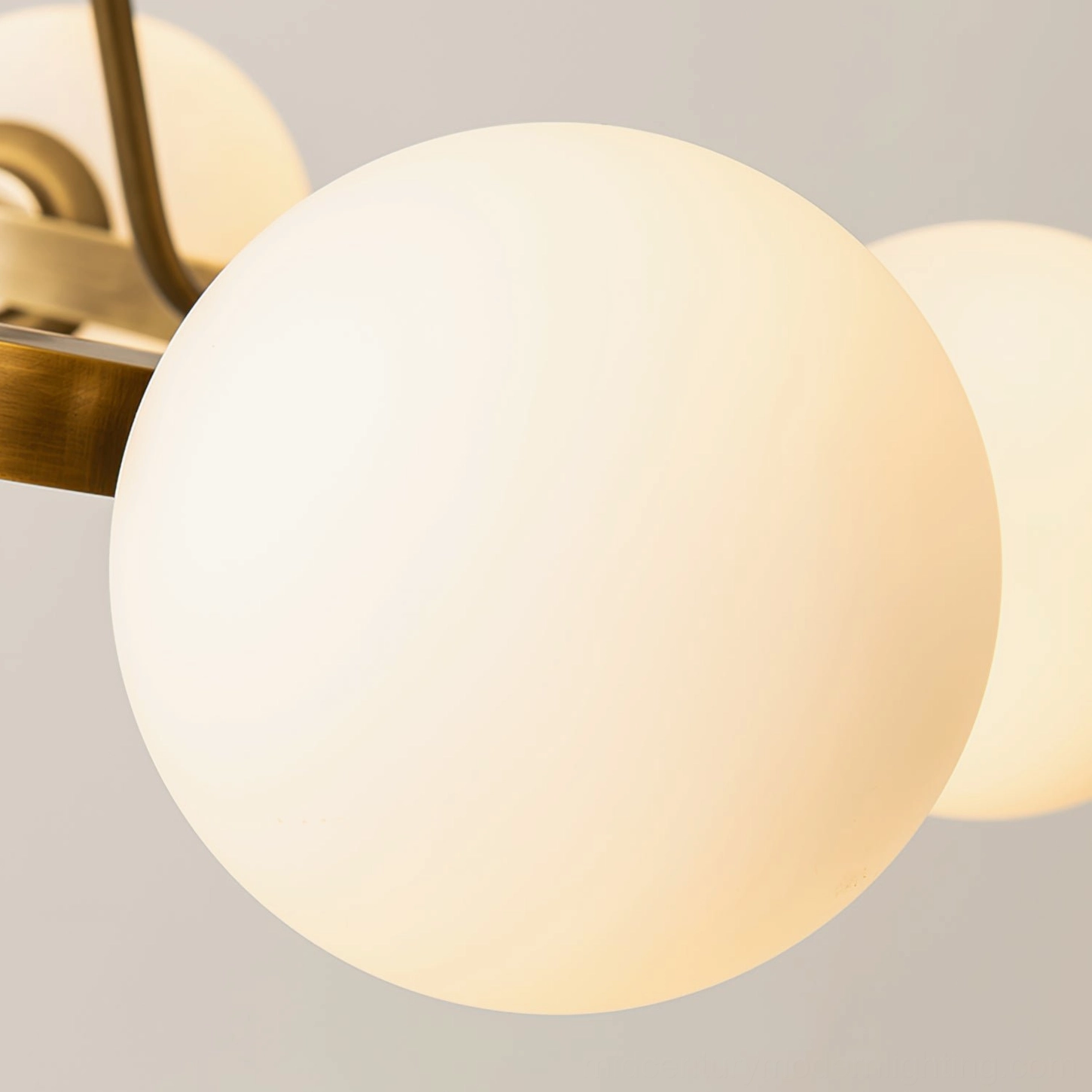 Frosted white glass lamp shade detail of Carolee chandelier, warm lit matte finish with brass frame