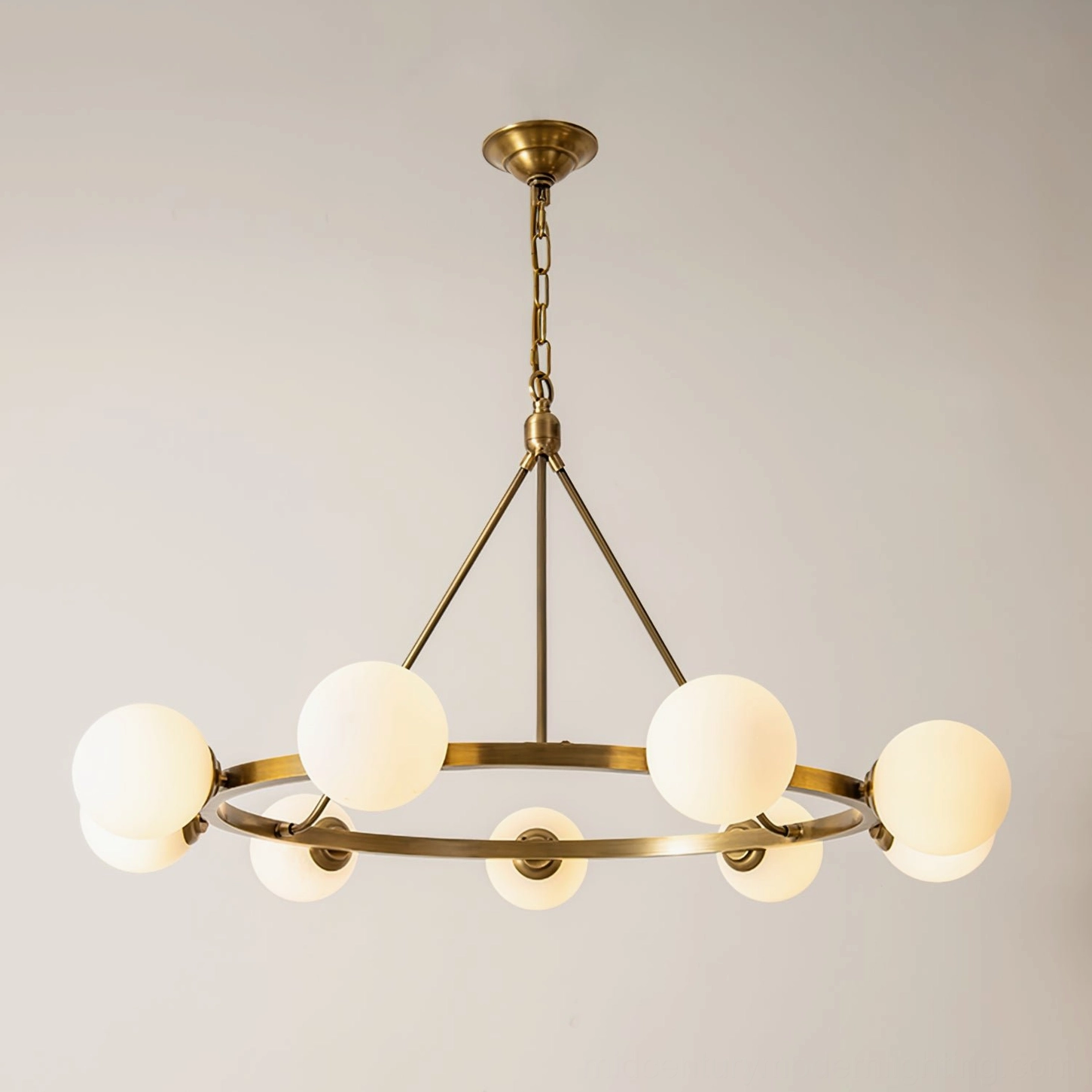 Minimalist Carolee mid-century modern pendant chandelier, flat front view showing circular brass frame and glass shades