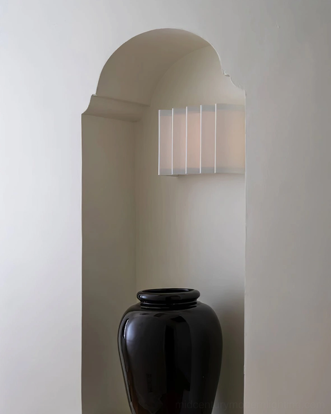 Minimalist compact white ribbed wall sconce front view on warm light wood background