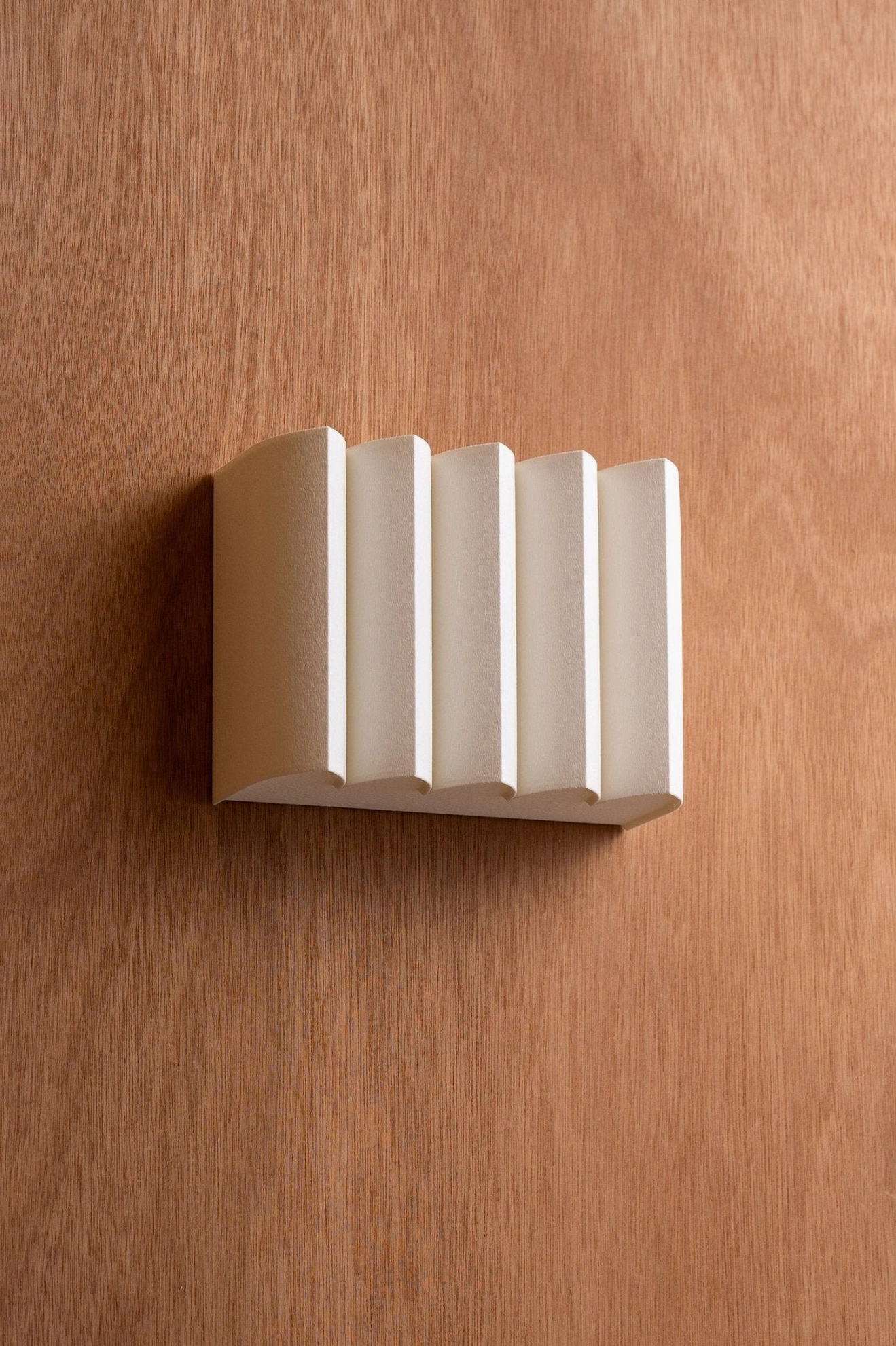 Beige linen wall lamp mounted on interior wall showing architectural mid-century aesthetic