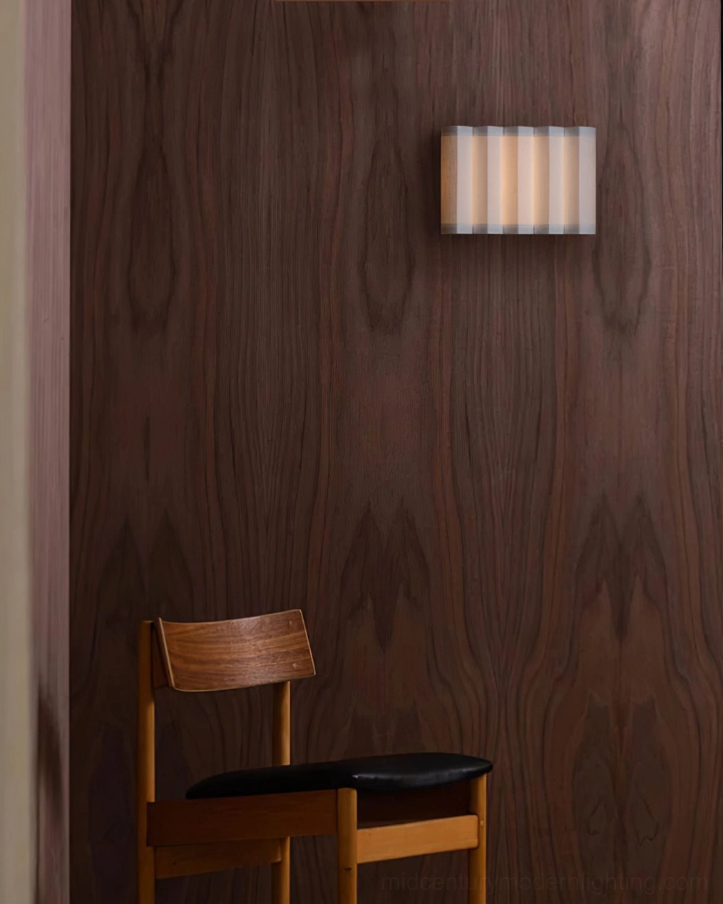Compact beige ribbed wall sconce in mid-century room with wooden chair