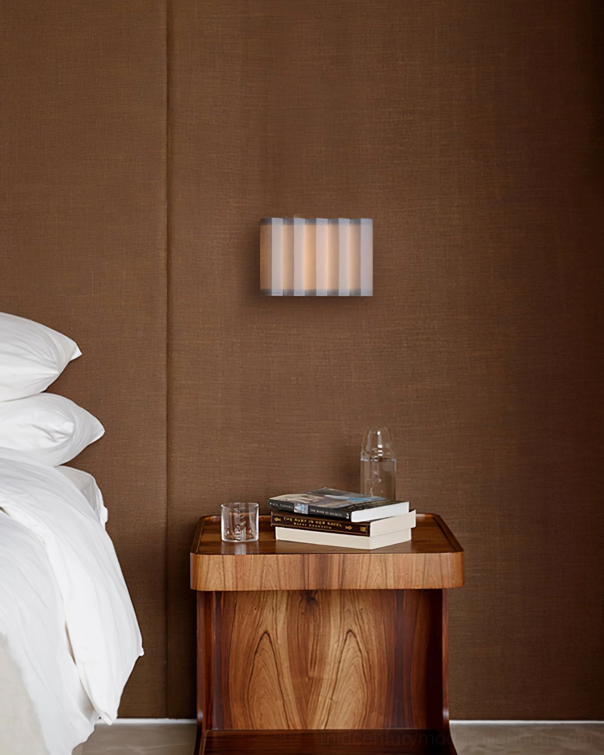 Mid-century bedroom wall lamp mounted above wooden nightstand, ambient bedroom lighting
