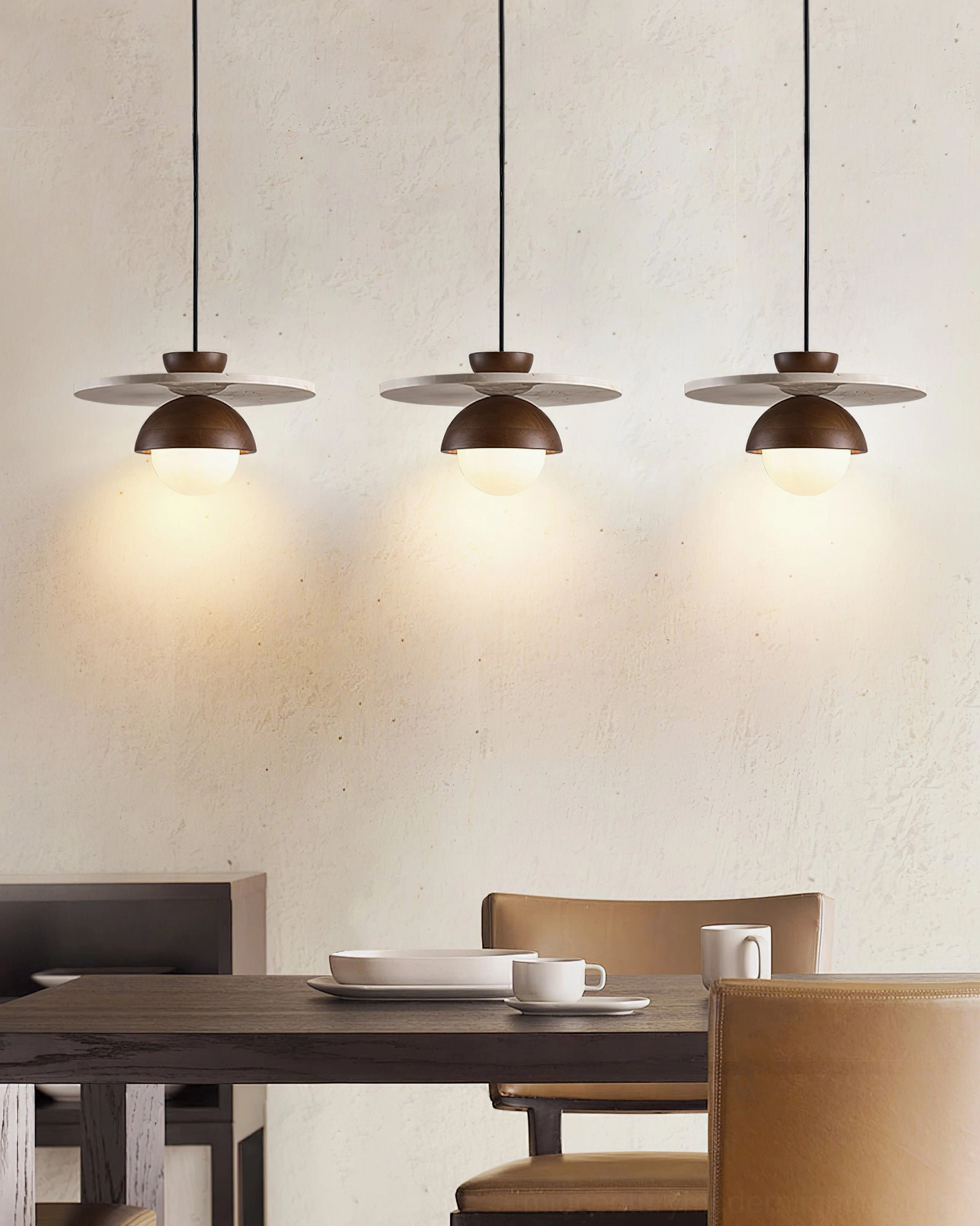 Multiple Cassini pendant lamps suspended above contemporary wooden dining table ambient lighting