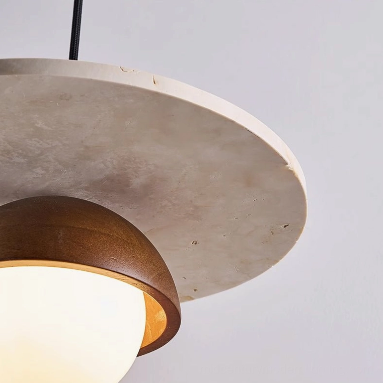 Close-up detail of Cassini pendant lamp showing wood grain texture stone finish and illuminated glass interior