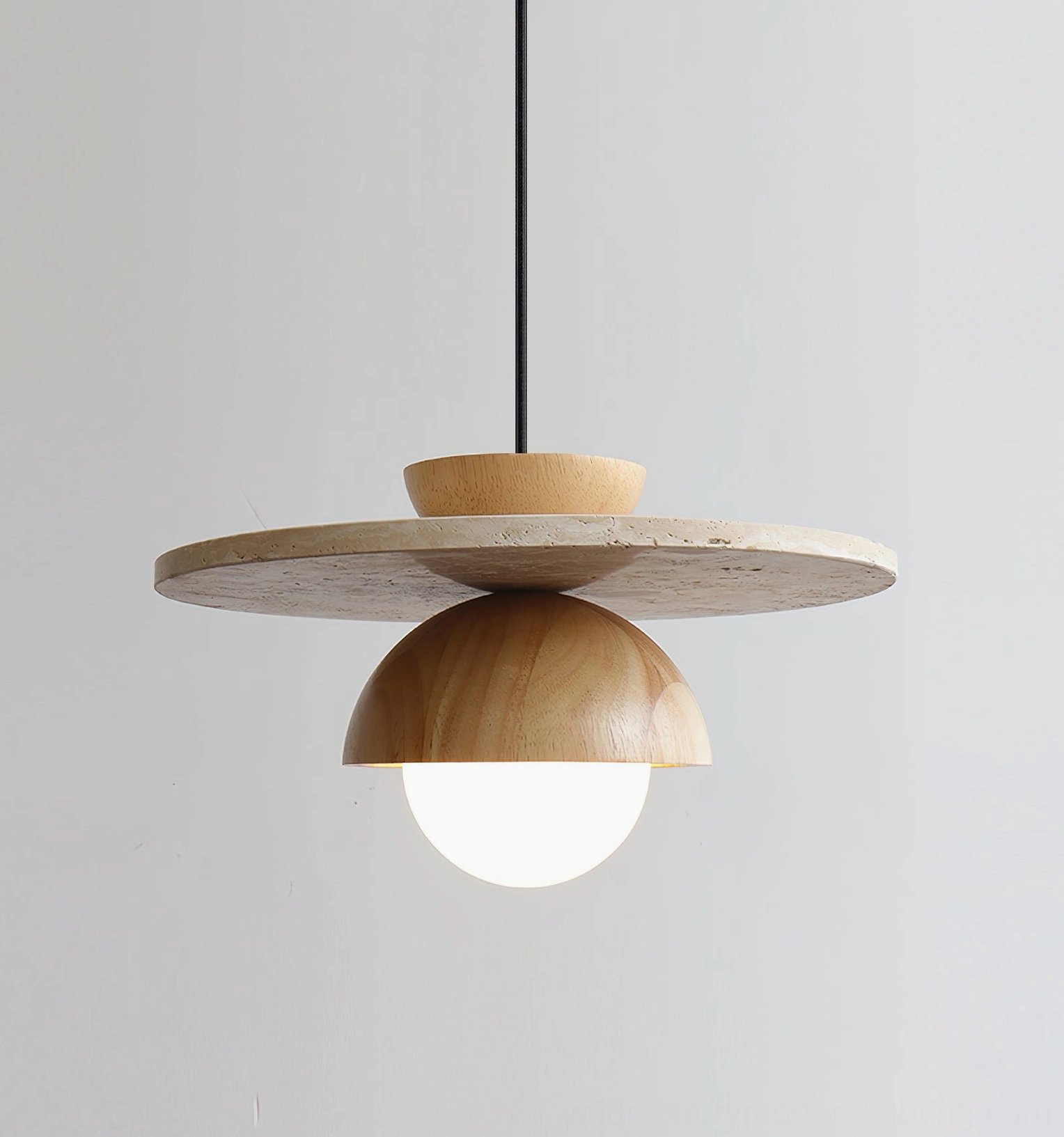 Cassini pendant light with light wood dome and beige travertine showing natural materials and craftsmanship