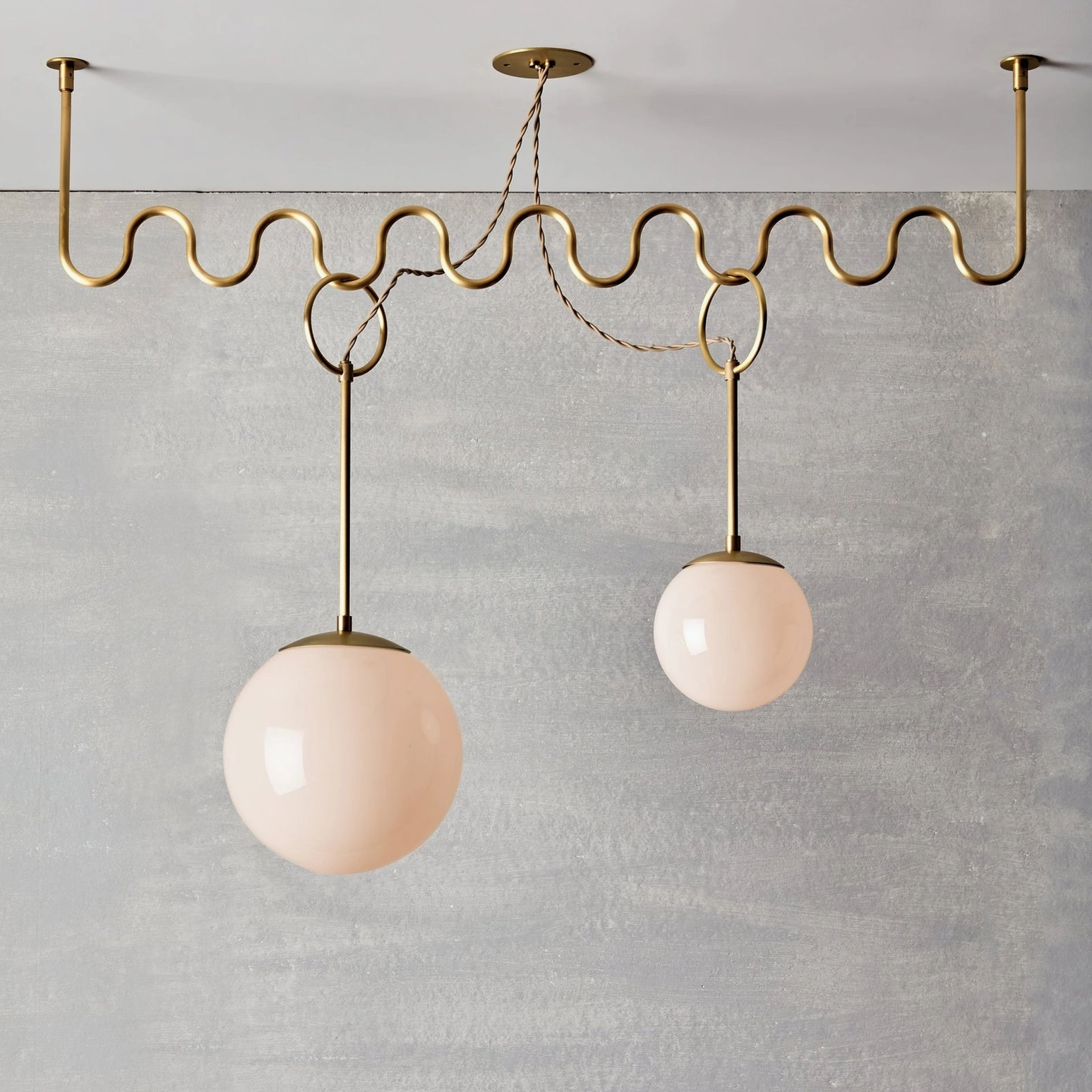 Cecil two-light wavy chandelier with blush pink frosted glass shades and twisted fabric suspension cord