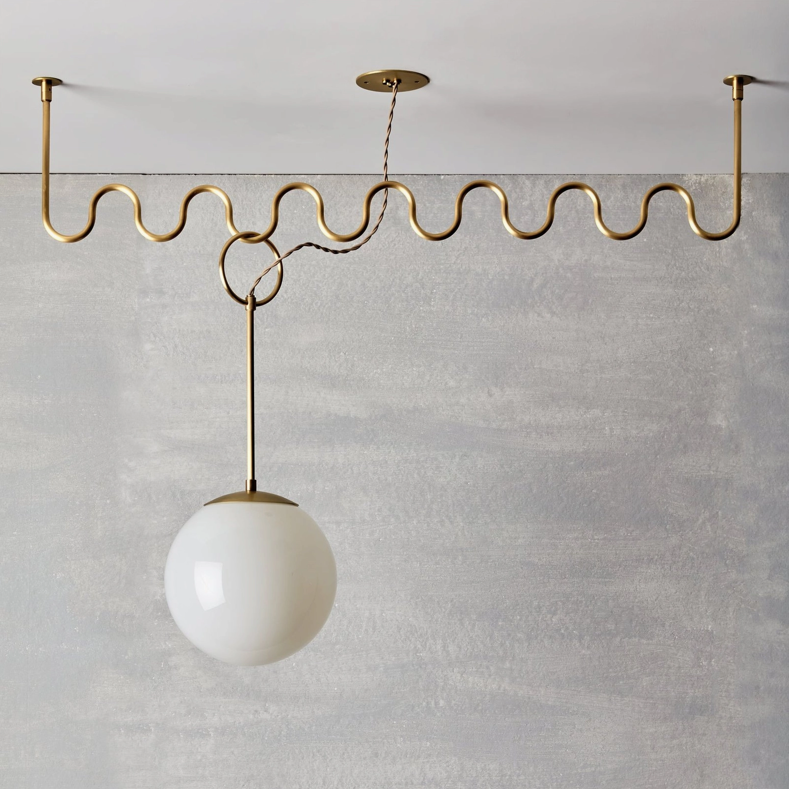 Cecil wavy brass chandelier architectural detail shot showing linked frame joints and geometric wave pattern
